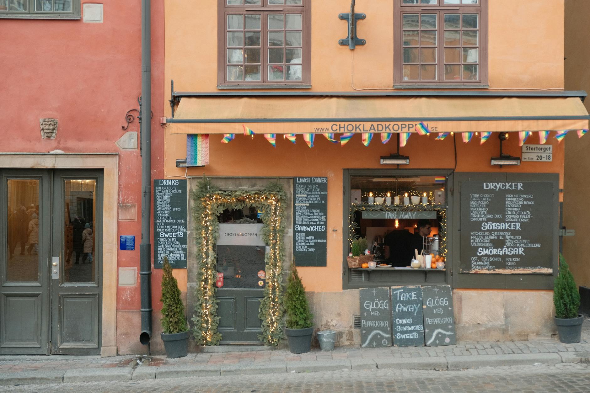 Cafe facade in Stockholm old town for woman traveler pause planning.