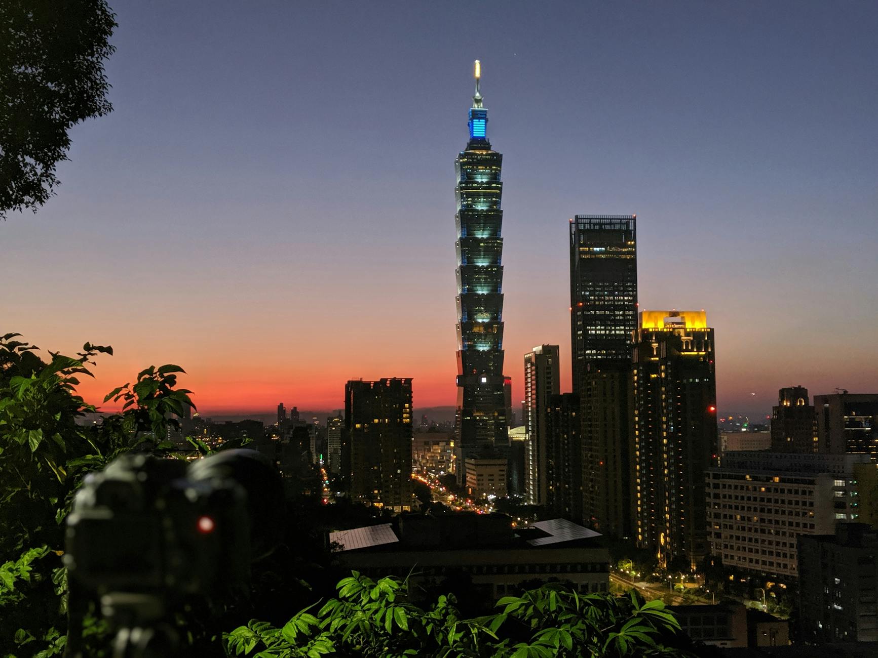 Taipei skyline and conference attendee planning context.
