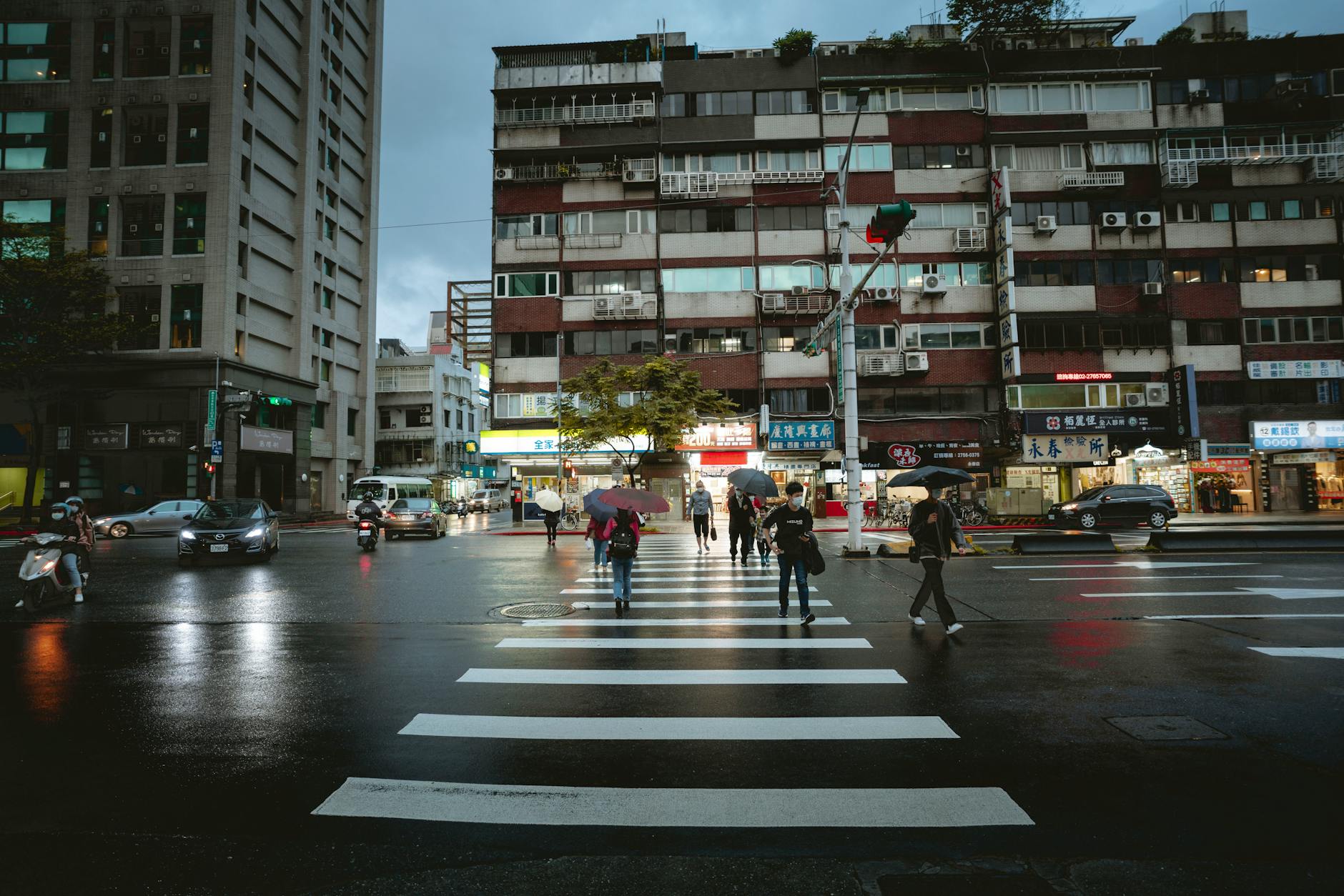 Rainy Taipei evening street and solo after-dark planning context.