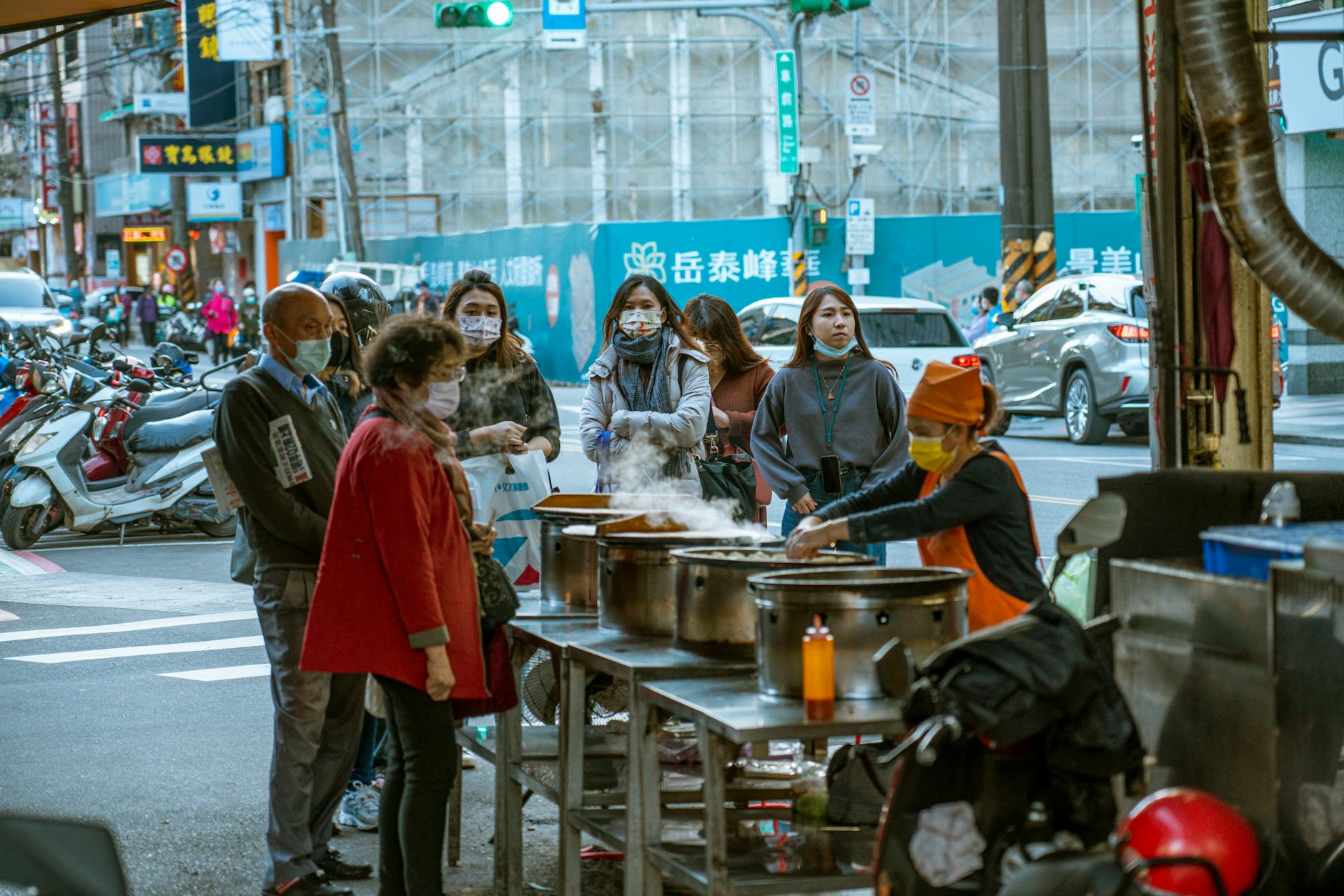 Rainy Taipei neighborhood and volunteer traveler recovery planning context.