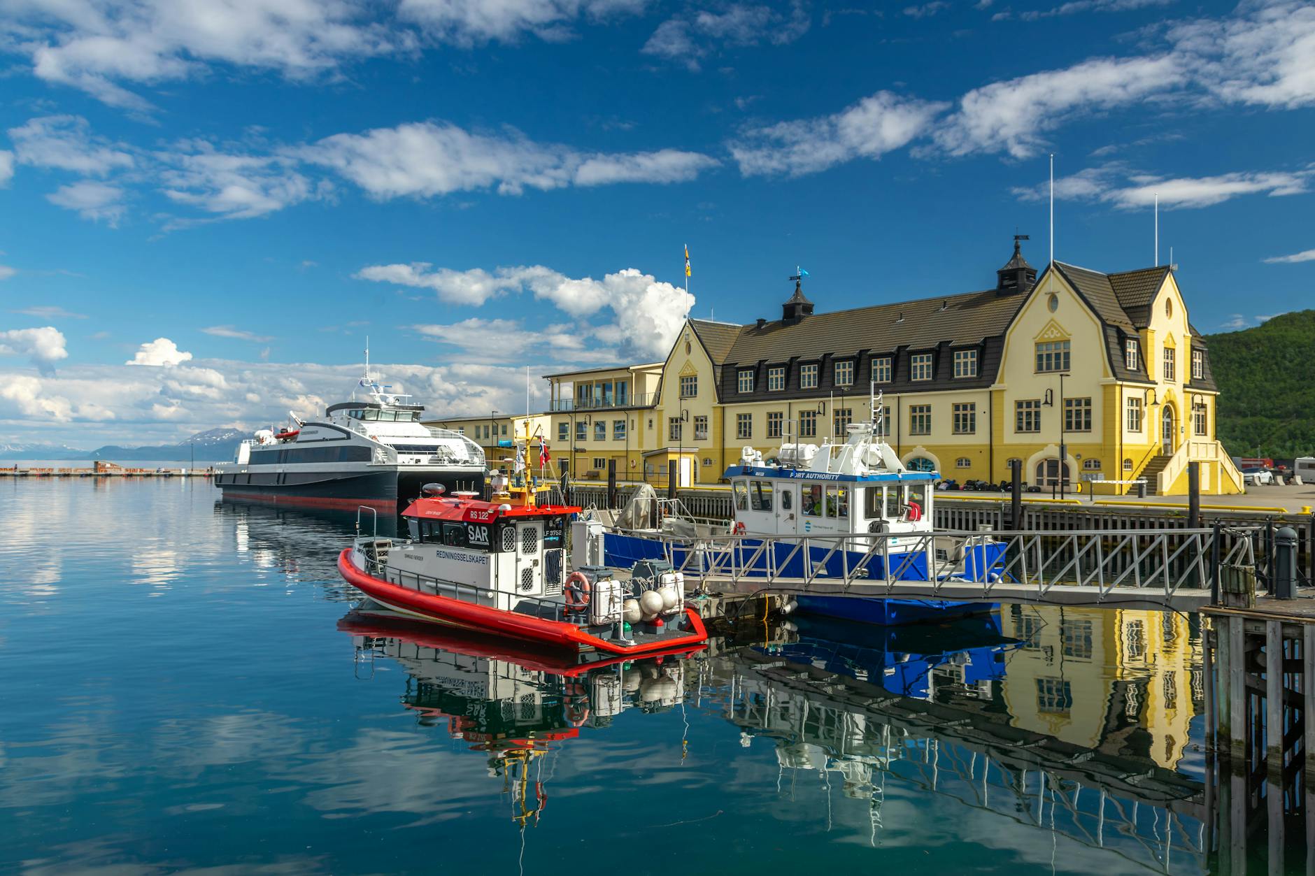 Ferry and boats in a Norwegian harbor for port-call meal and payment planning.