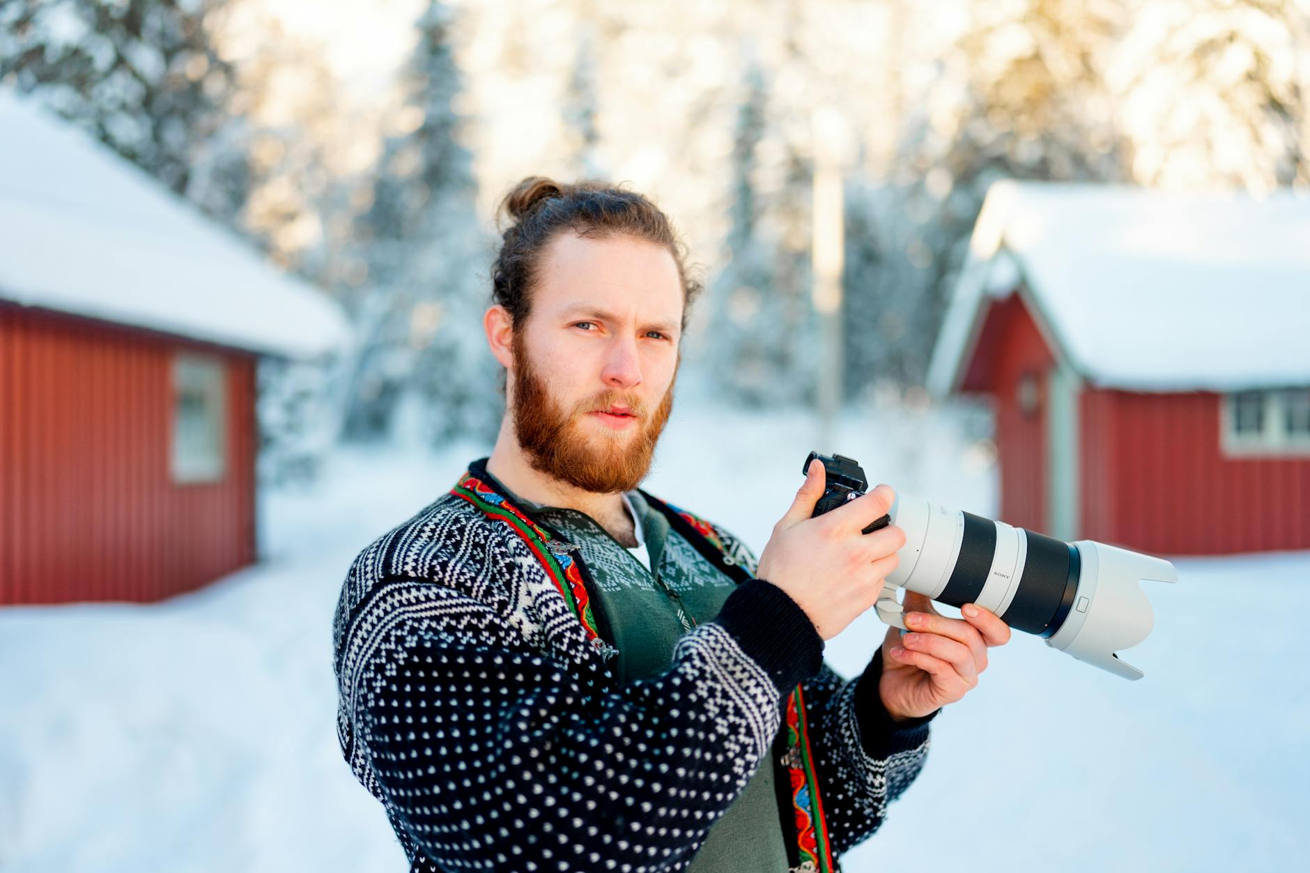 Photographer holding a camera for Trondheim journalism travel report planning.