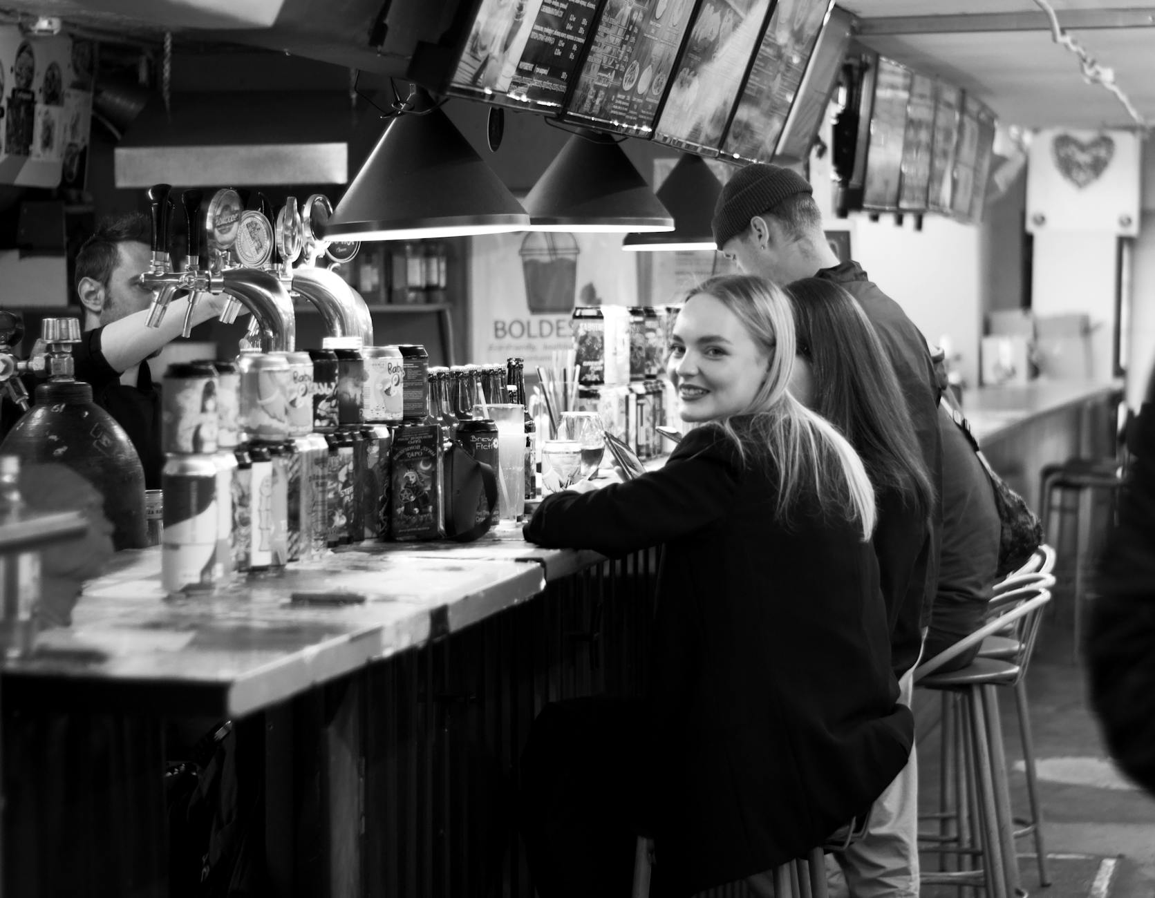 Traveler at a bar for Trondheim hotel-return planning.