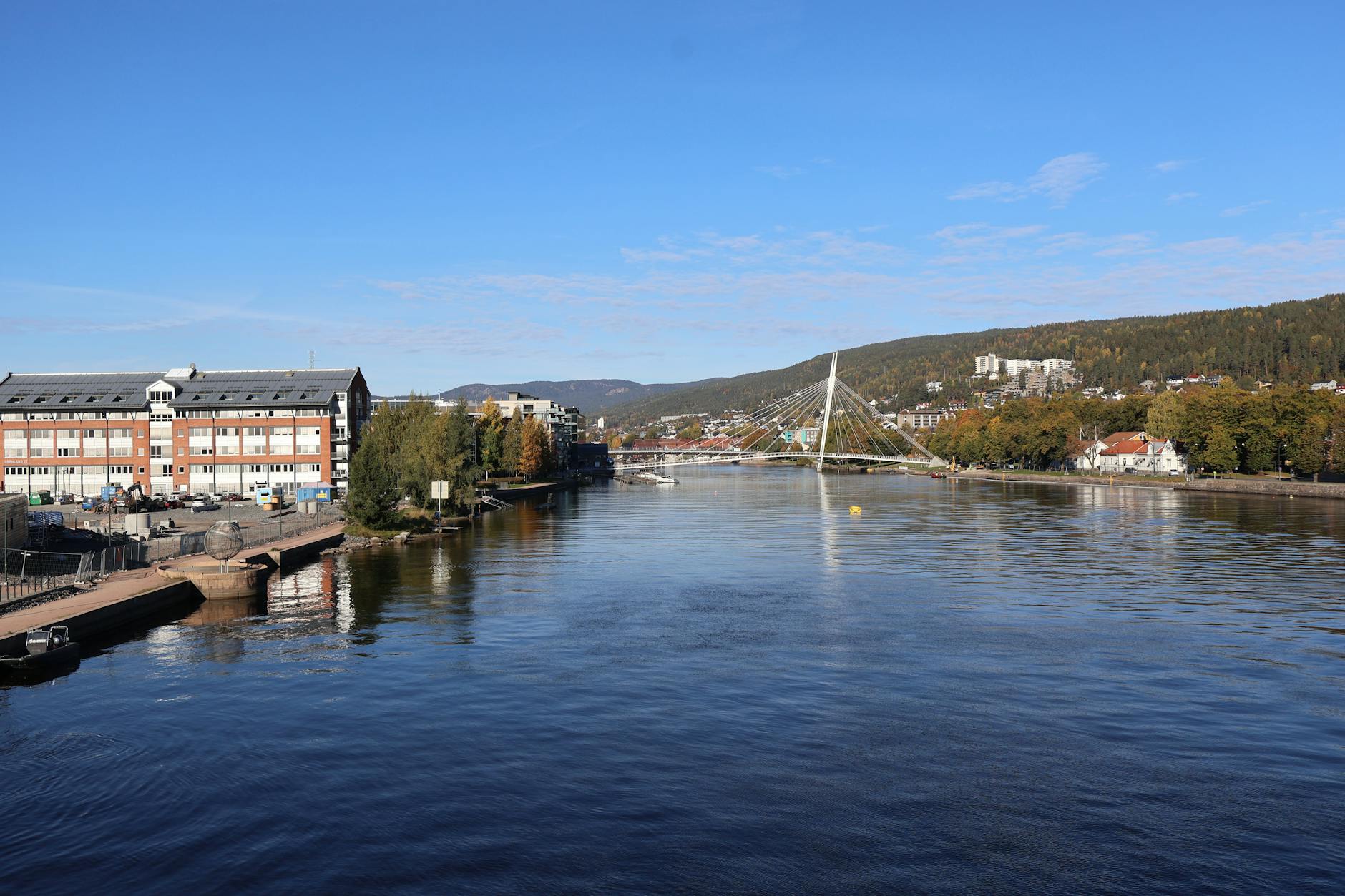 Norwegian riverside bridge for Trondheim sales travel report planning.