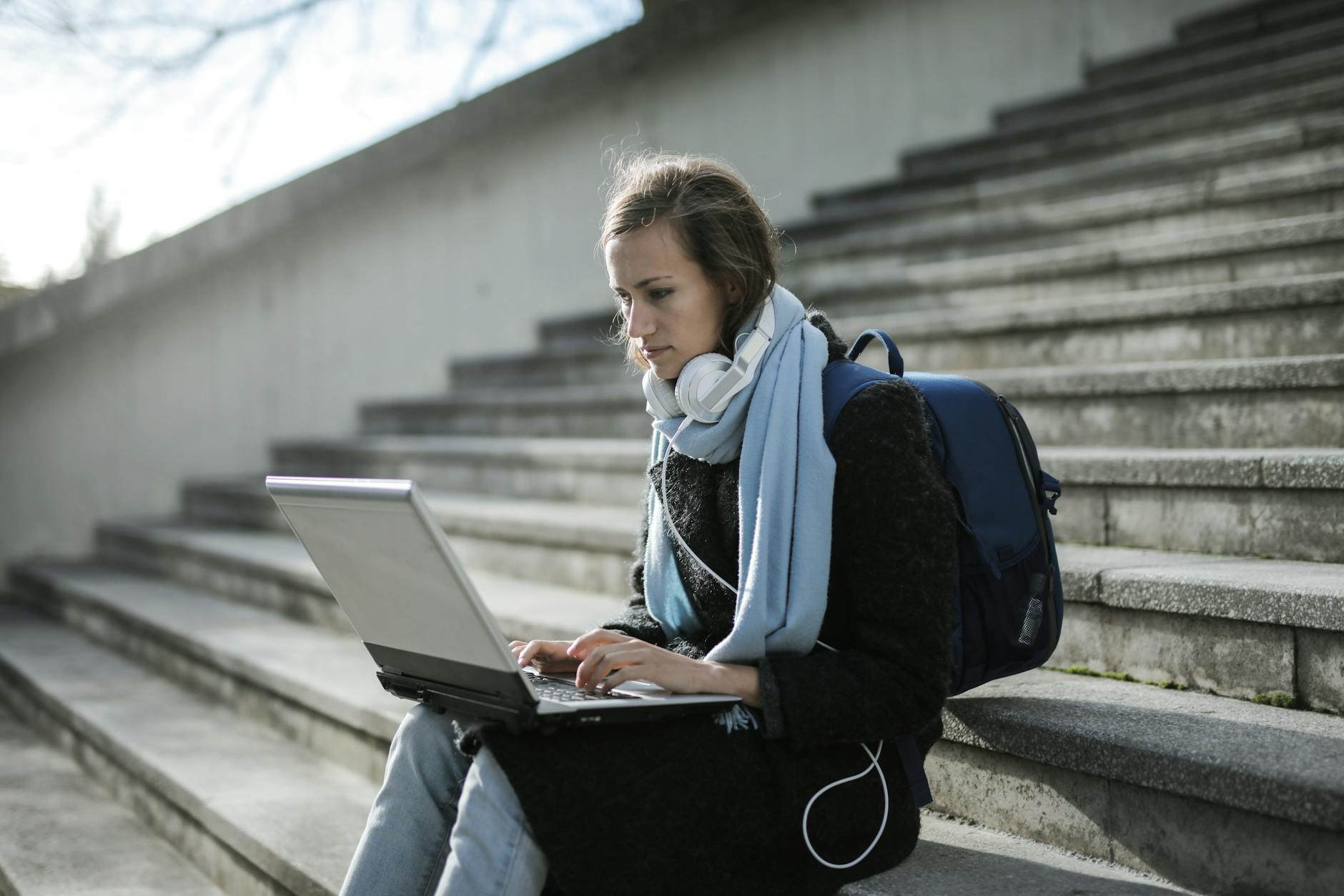 Student with laptop outside for Trondheim weekend planning.
