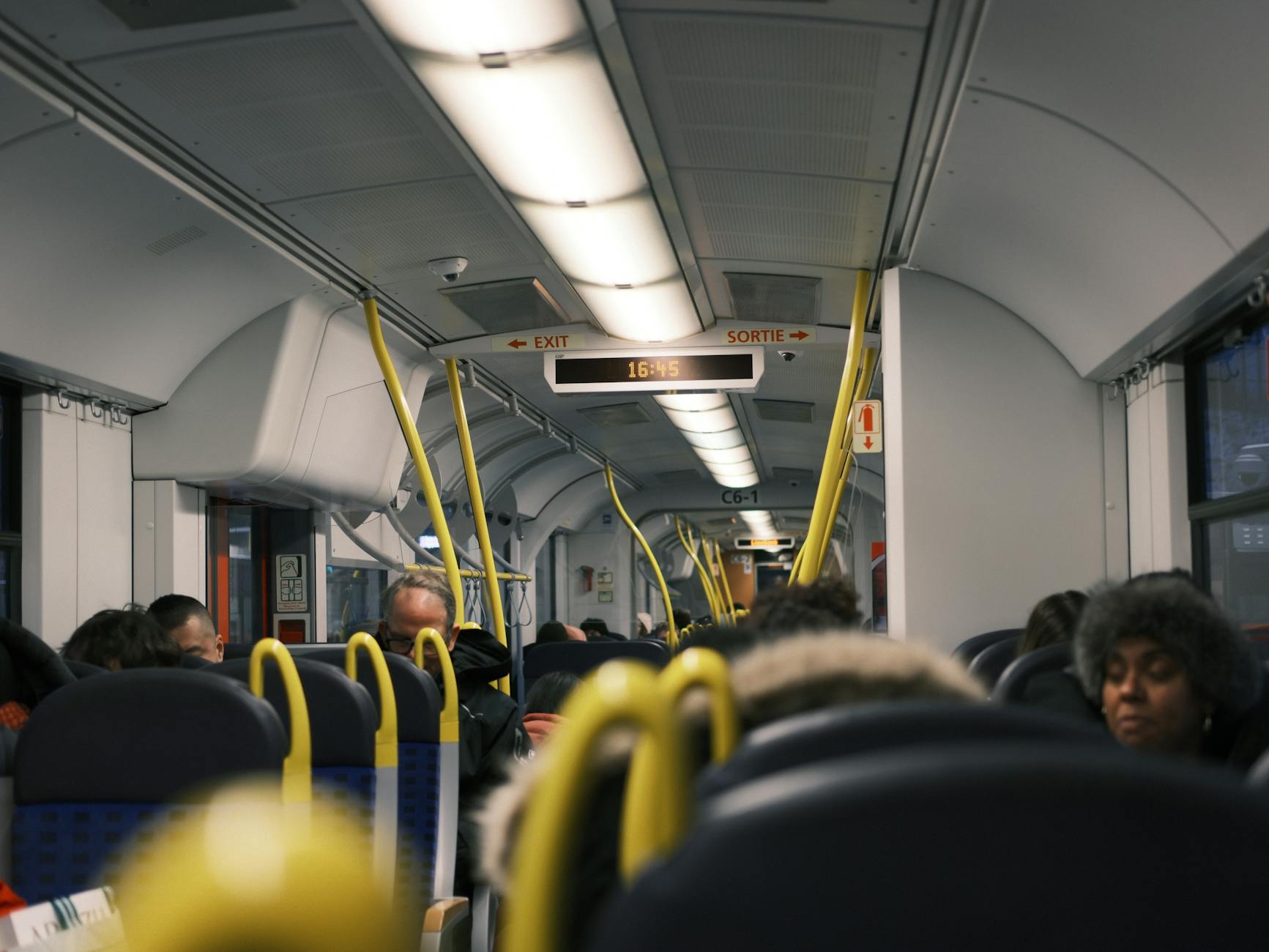 Commuters on a train for Trondheim transit report planning.