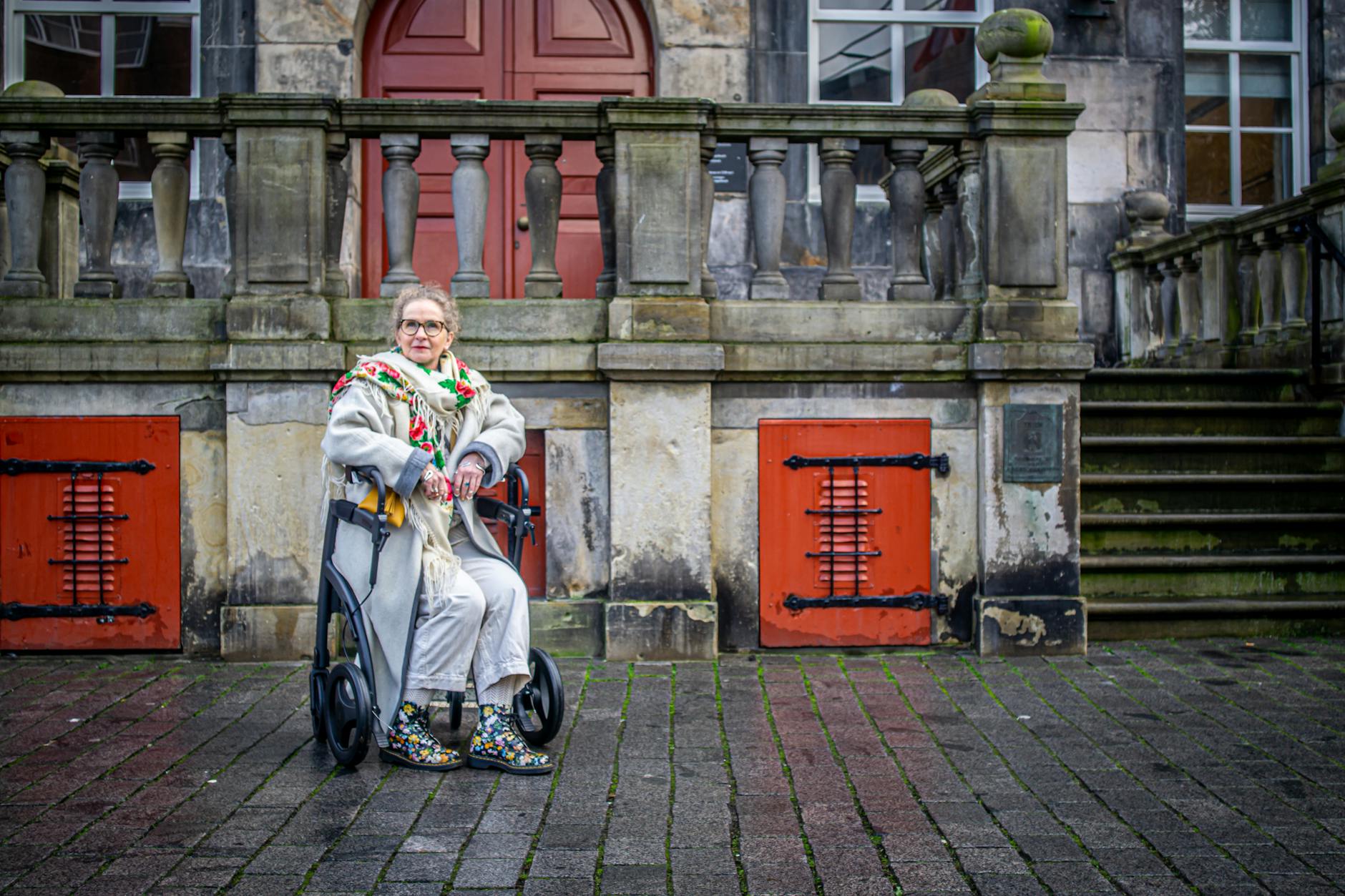Wheelchair user on paving stones for Trondheim lodging access planning.