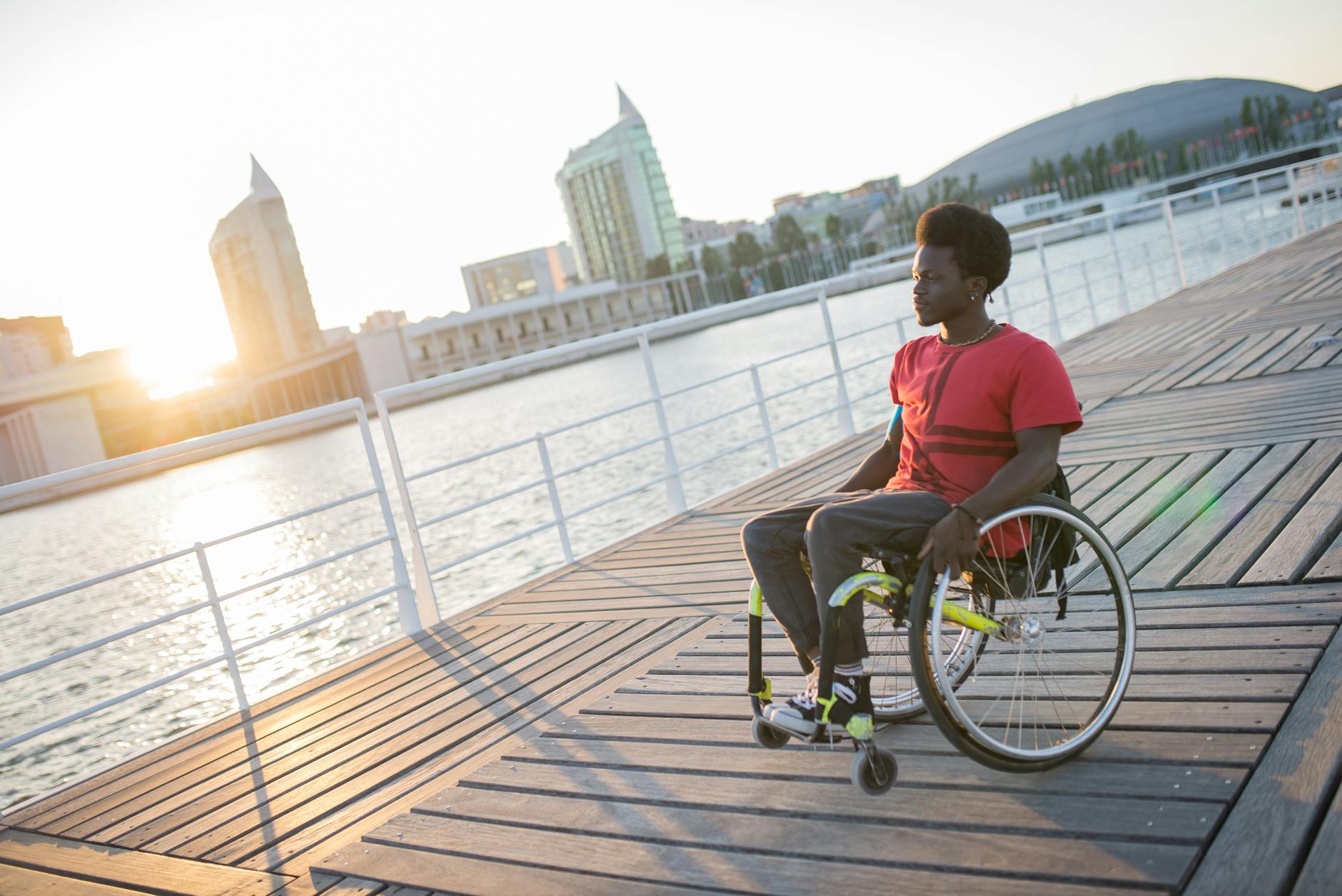 Wheelchair user near water for Trondheim access-needs planning.