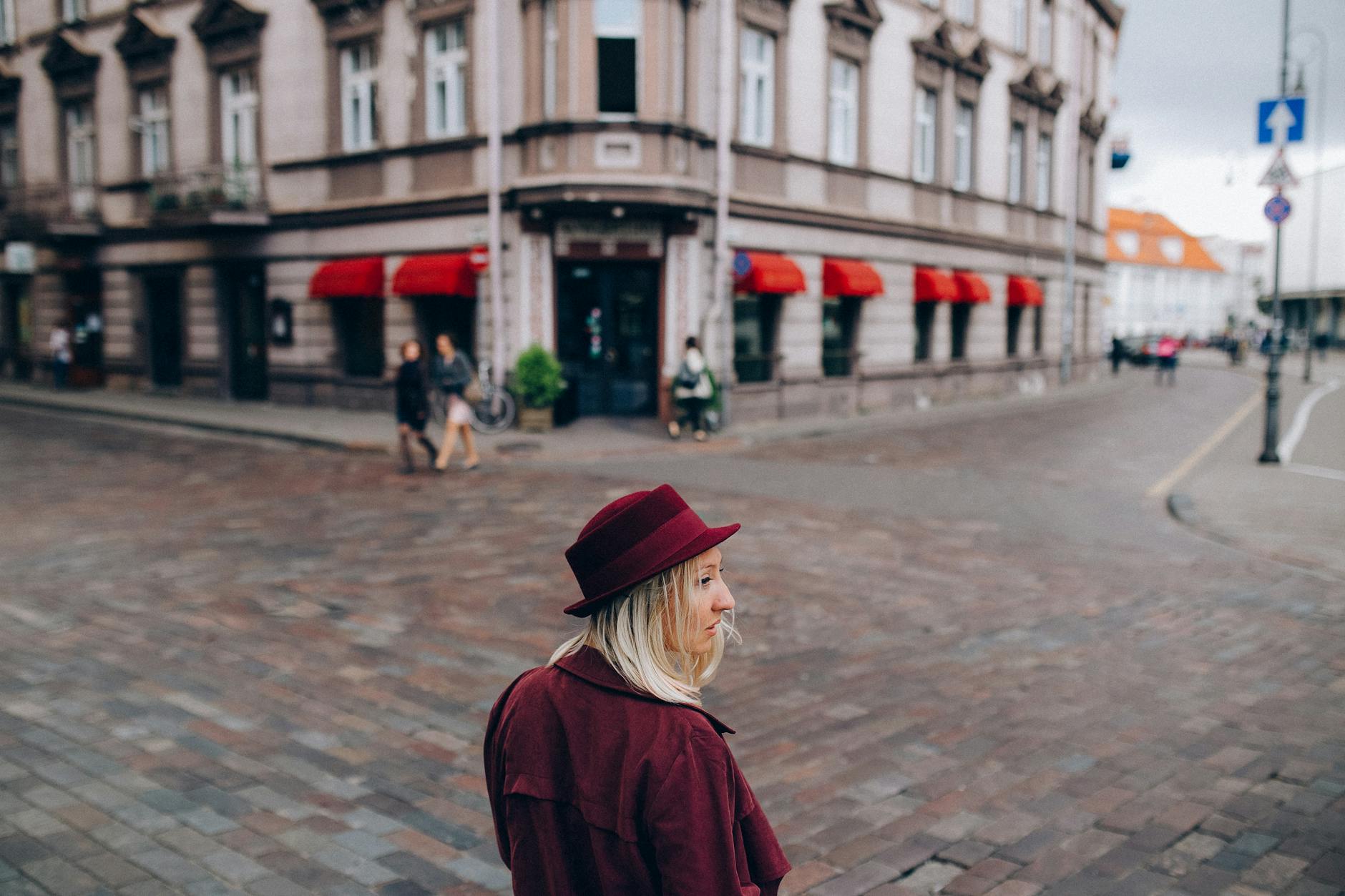 Woman in a red coat for Trondheim hotel and arrival confidence planning.