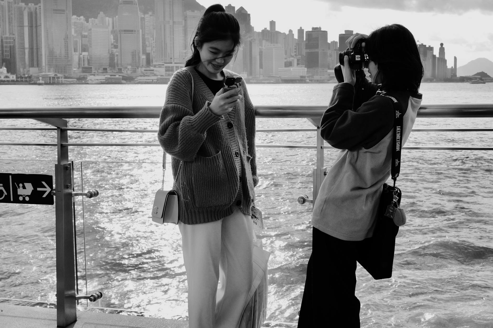 Camera waterfront context and journalist planning in Tsim Sha Tsui.