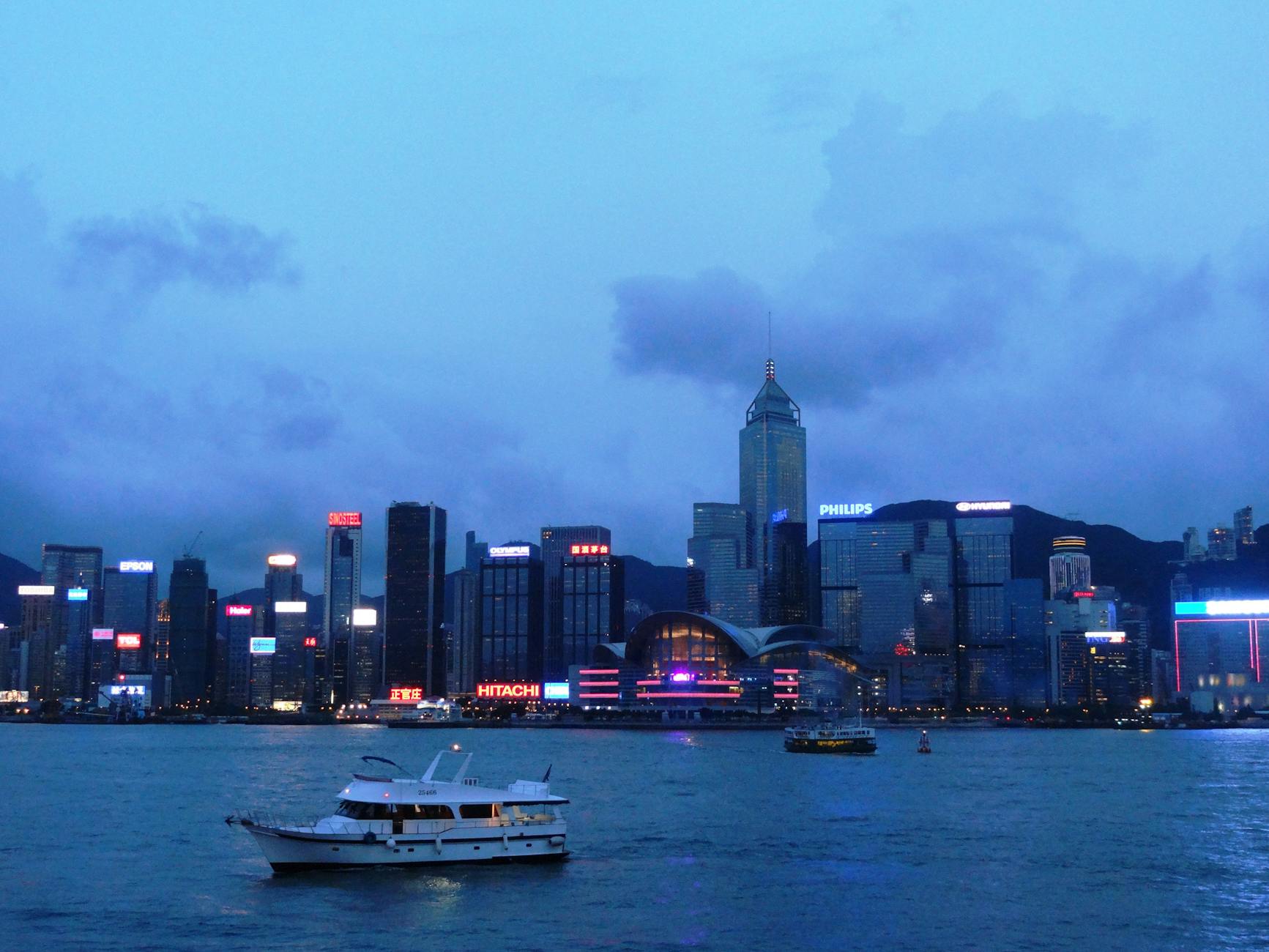 Tsim Sha Tsui night skyline and volunteer traveler planning context.