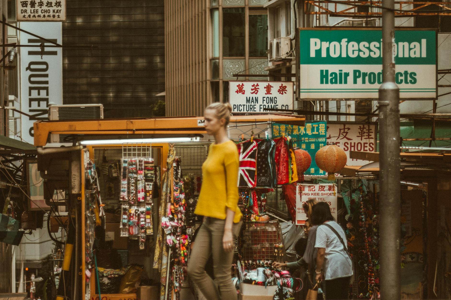 Tsim Sha Tsui shopping street and woman traveler weather planning context.