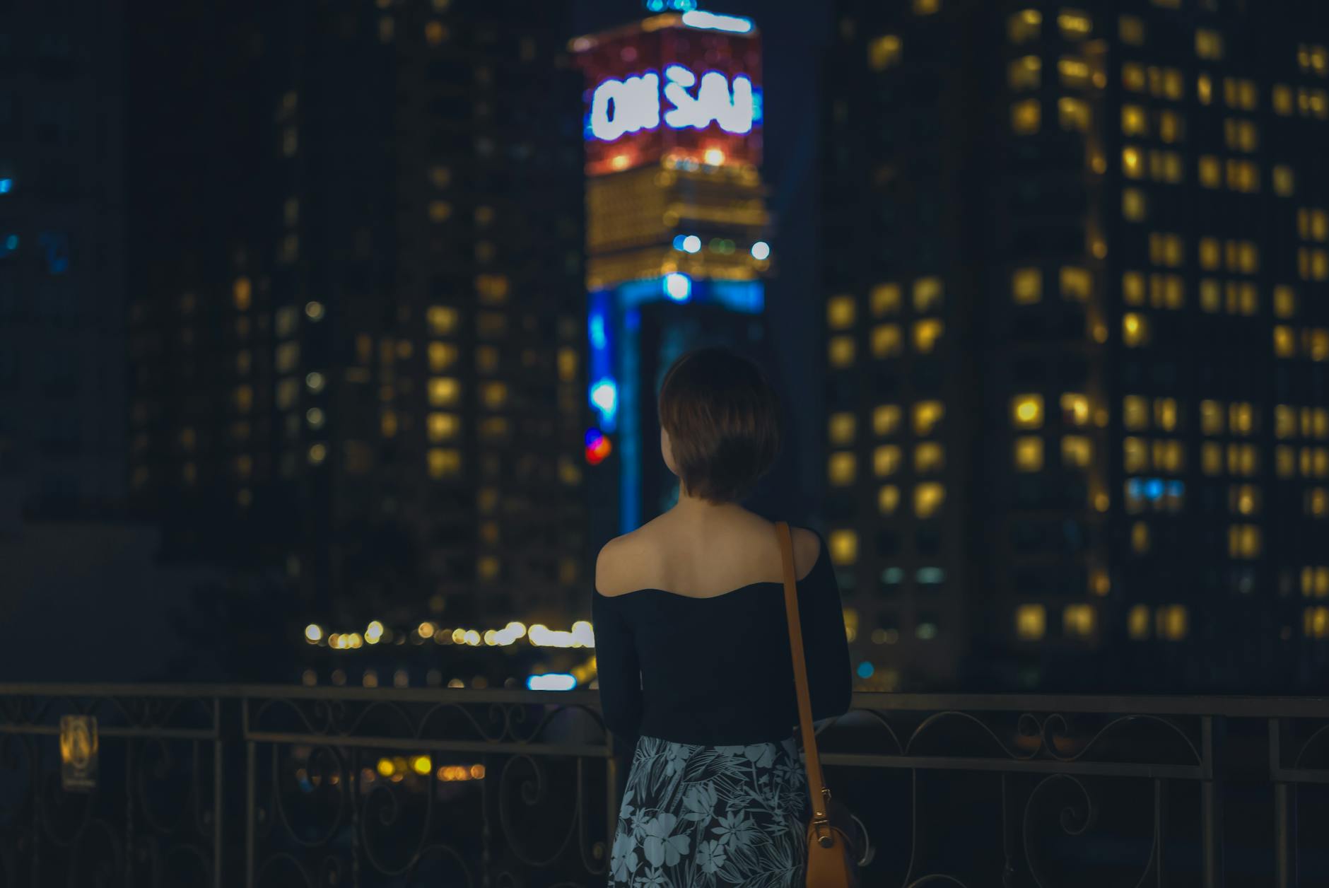 Tsim Sha Tsui night skyline and woman traveler planning context.