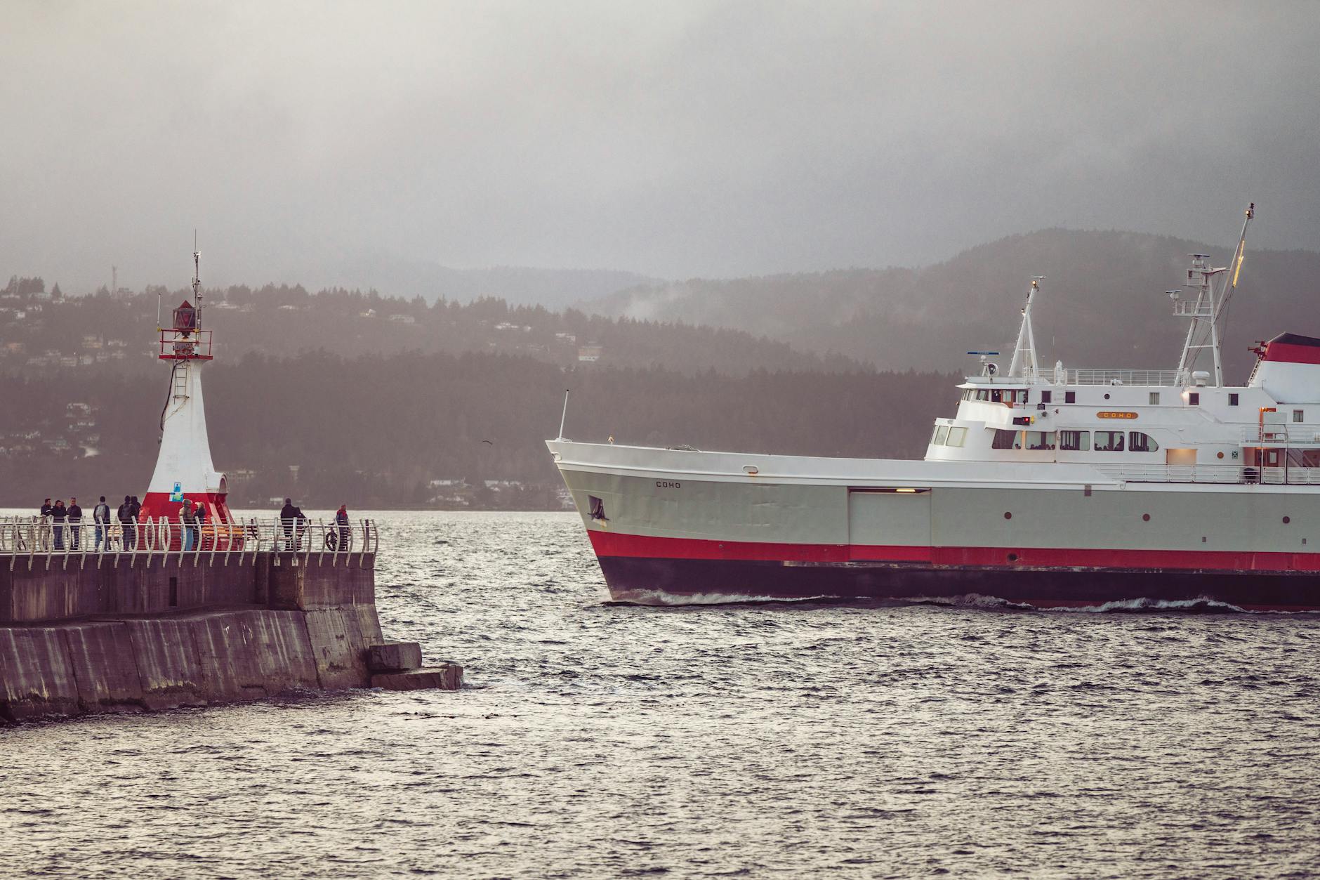 Ferry approaching a breakwater lighthouse in Victoria
