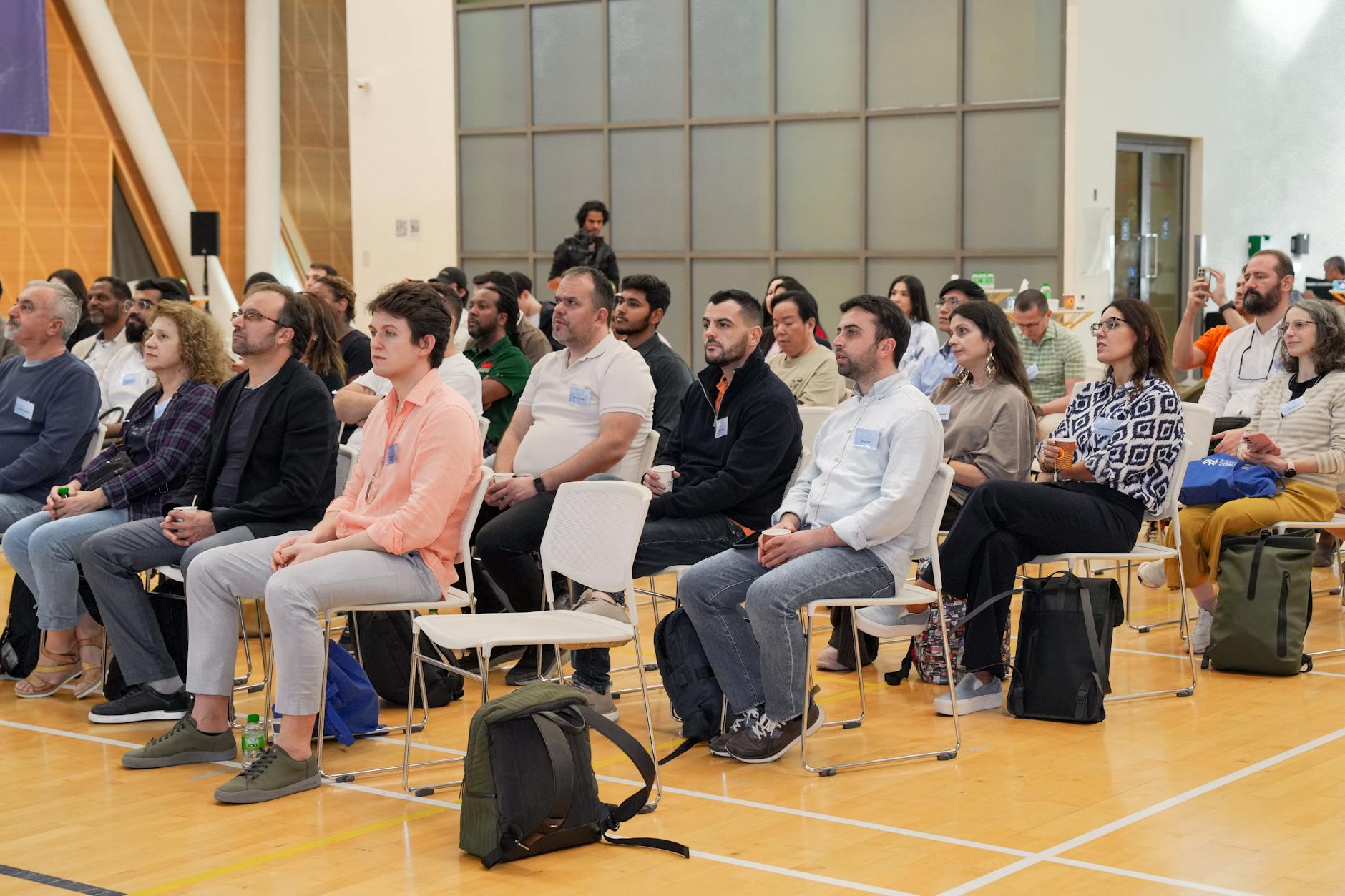 Adults listening attentively in an indoor conference setting