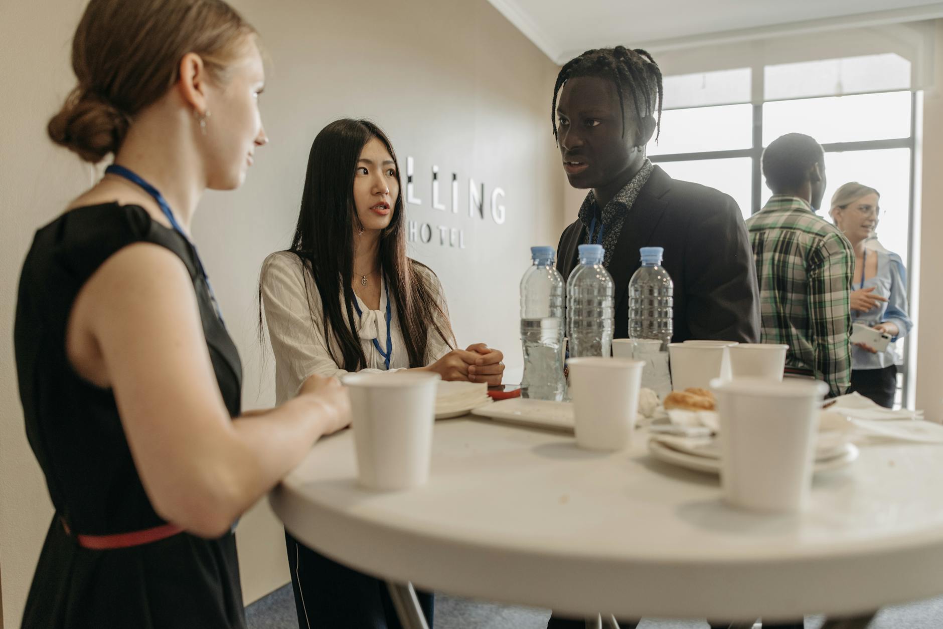 Professionals networking at a business event with refreshments