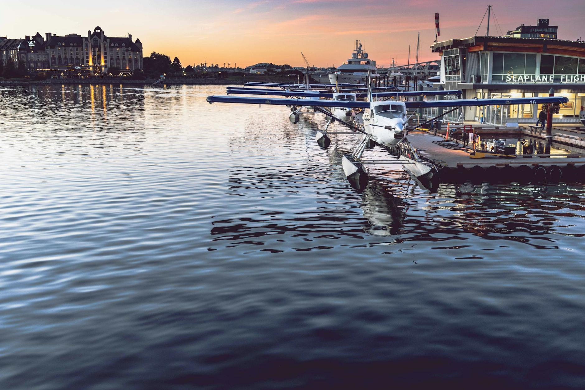 Seaplane docked at Victoria Harbor during sunset