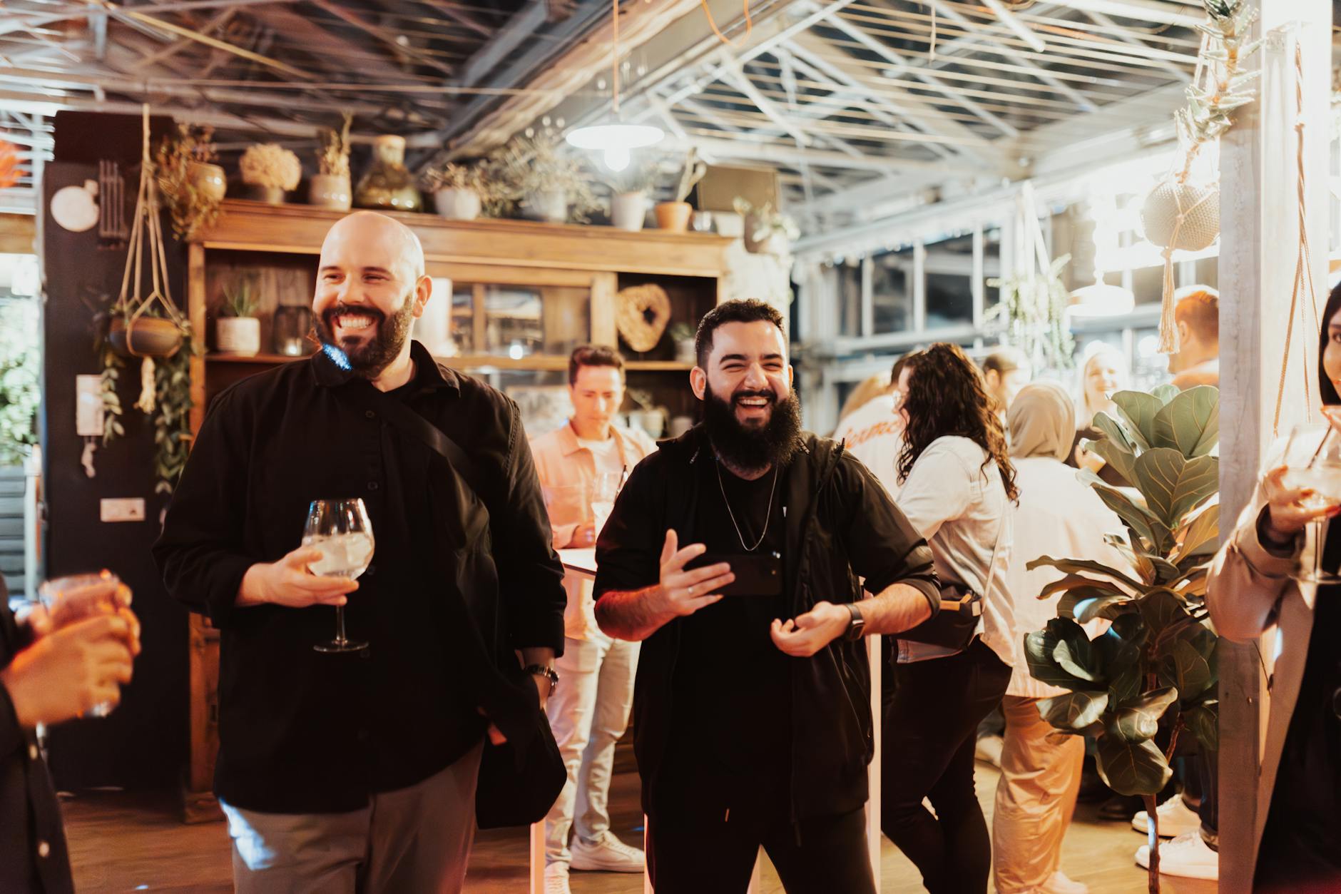 Indoor gathering with people enjoying drinks and conversation