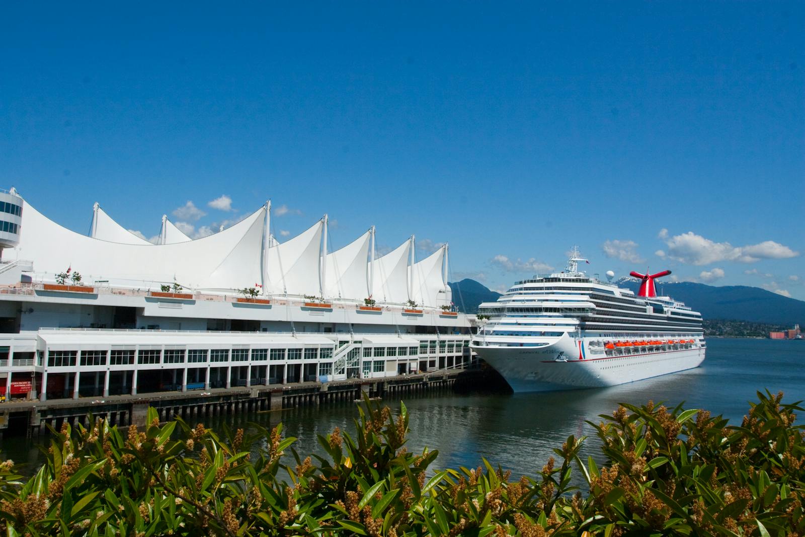 Cruise ship docked at Canada Place in Vancouver on a sunny day.