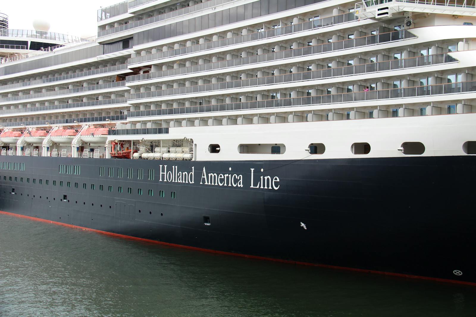 Close-up view of a Holland America Line cruise ship docked in Vancouver harbor.
