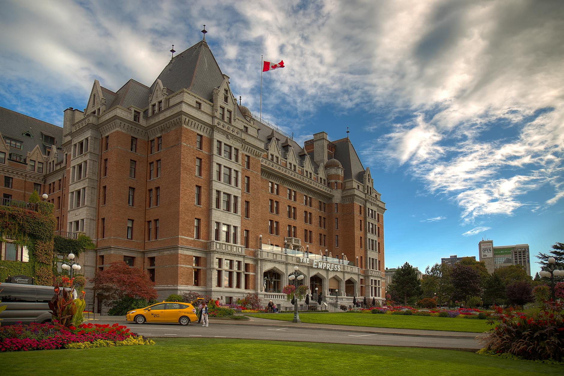 Fairmont Empress Hotel in Victoria with gardens and Canadian flag