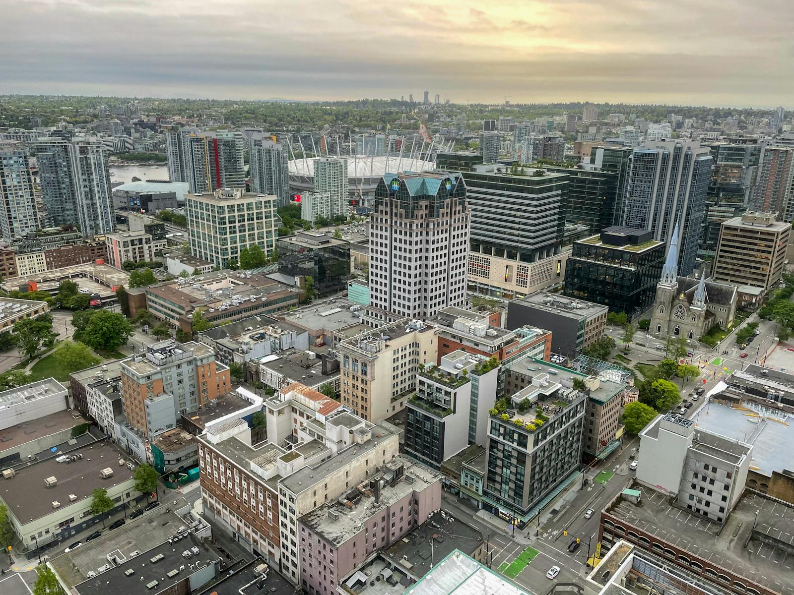 Capture of Vancouver's architectural landscape from above during sunset, highlighting urban density and city life.