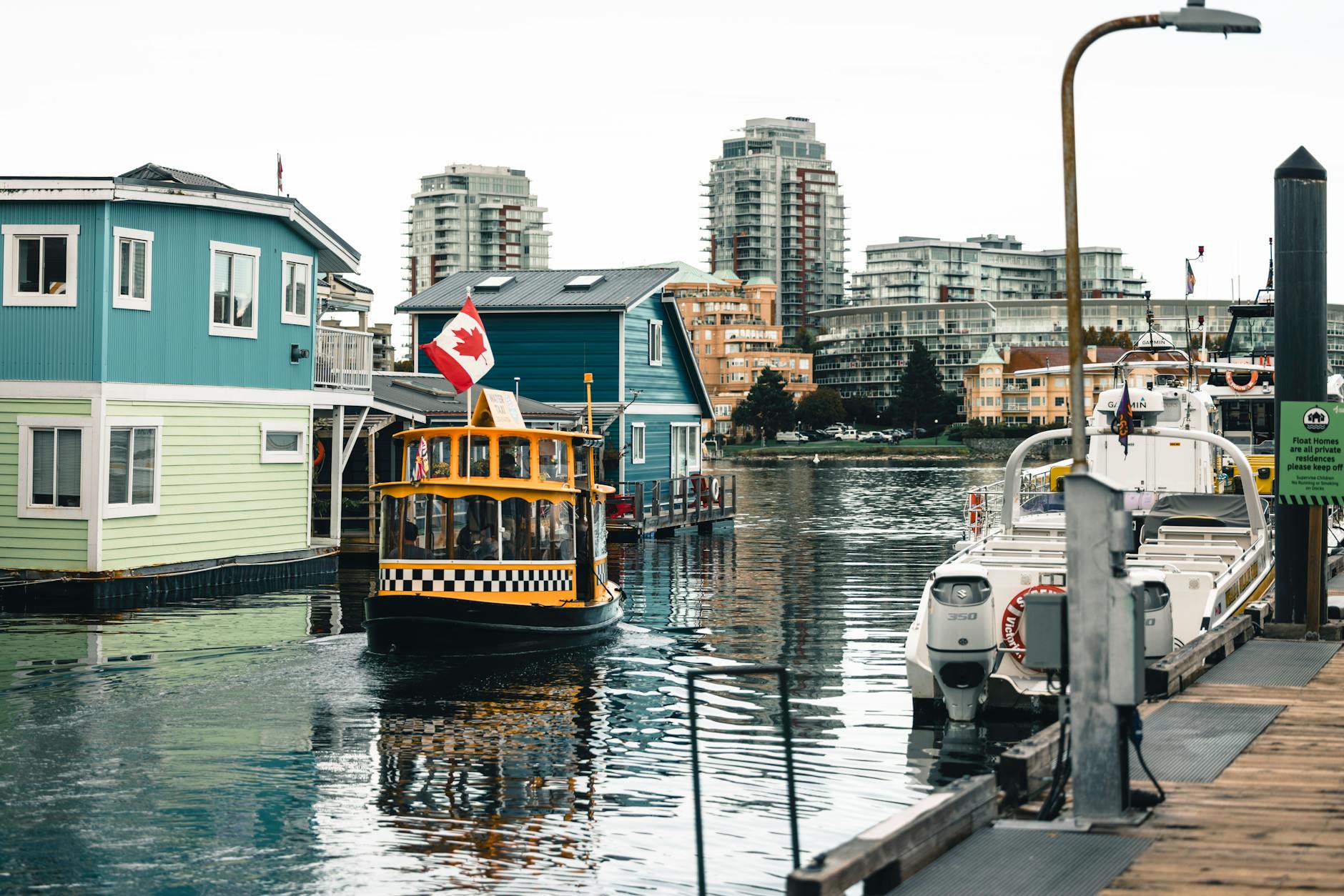 Water taxi and floating homes in Victoria Harbour