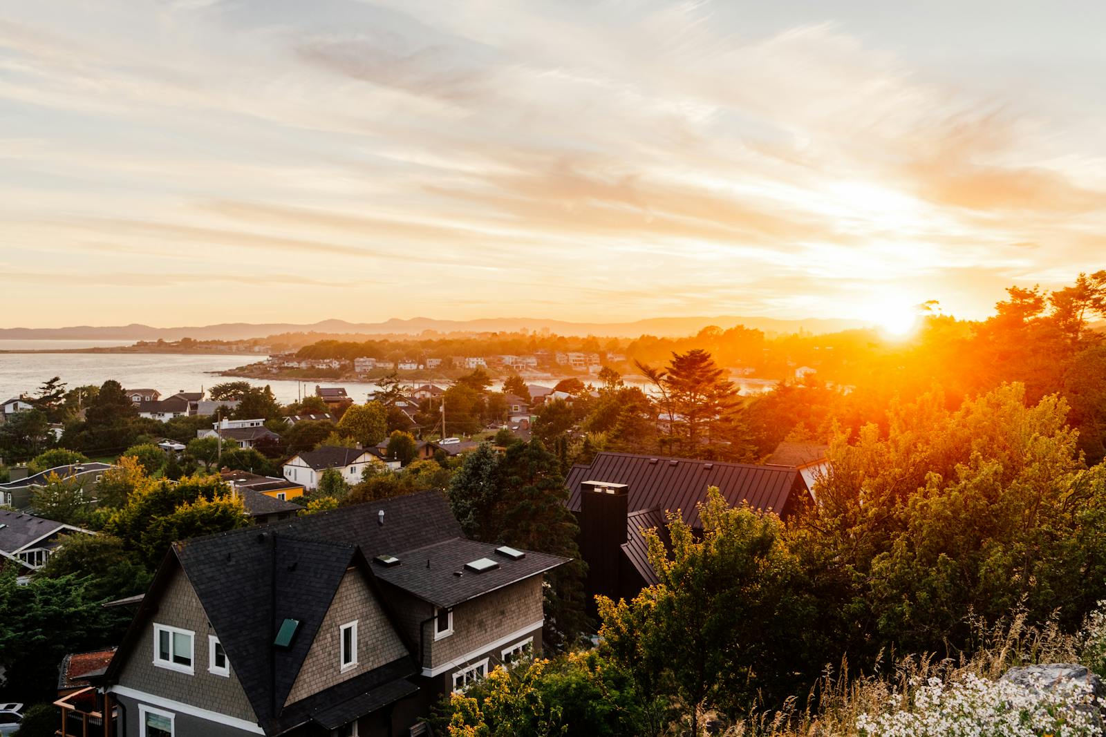 Breathtaking sunset view over a residential area in Victoria, BC, Canada with vibrant colors.