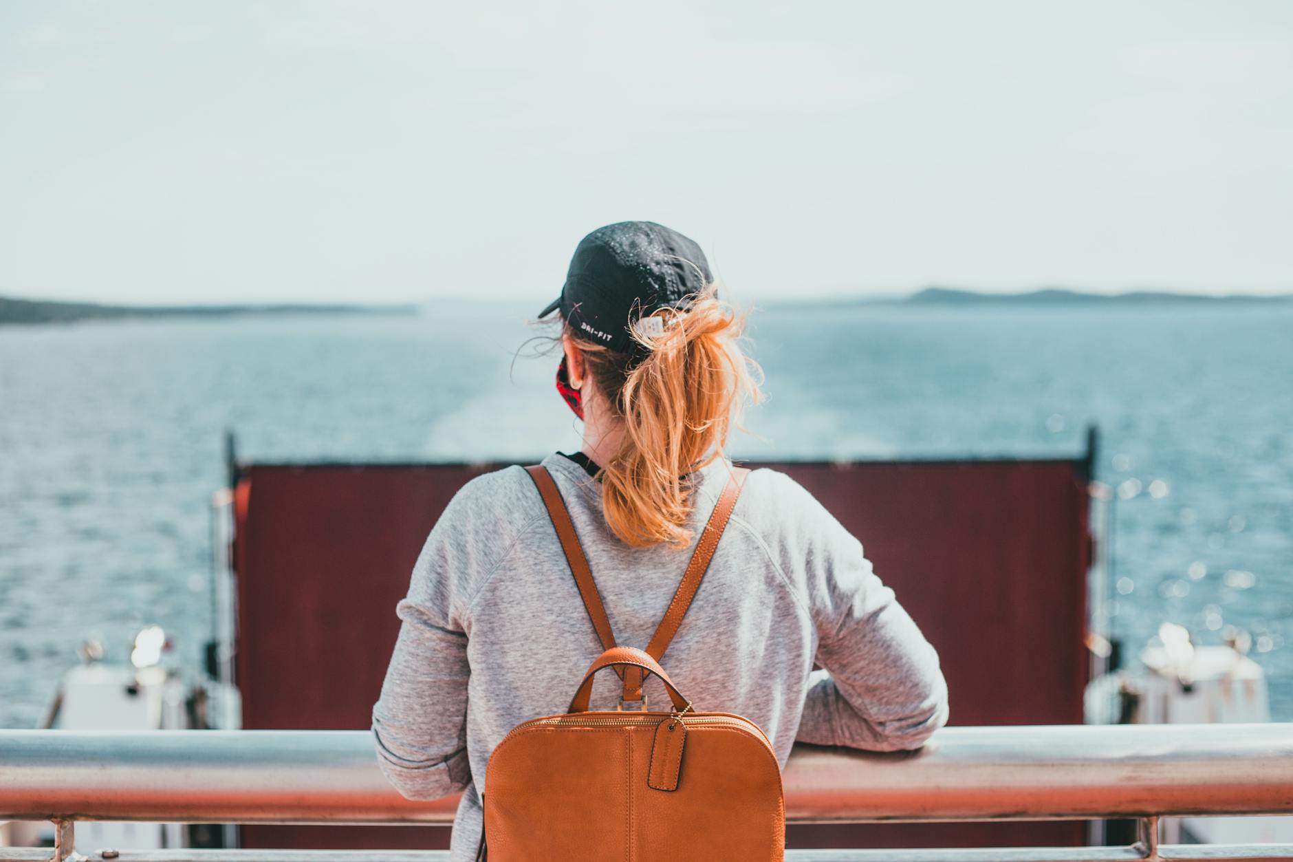 Woman on a ferry looking out over the ocean