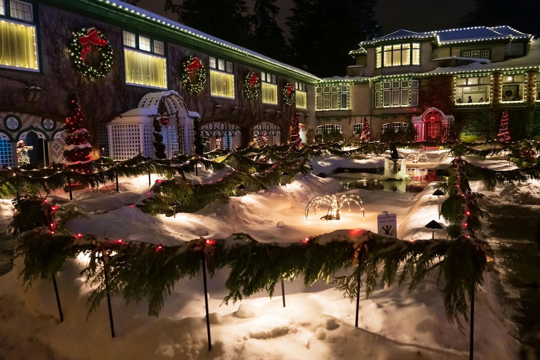 Decorated mansion with festive Christmas lights in winter, Brentwood Bay.