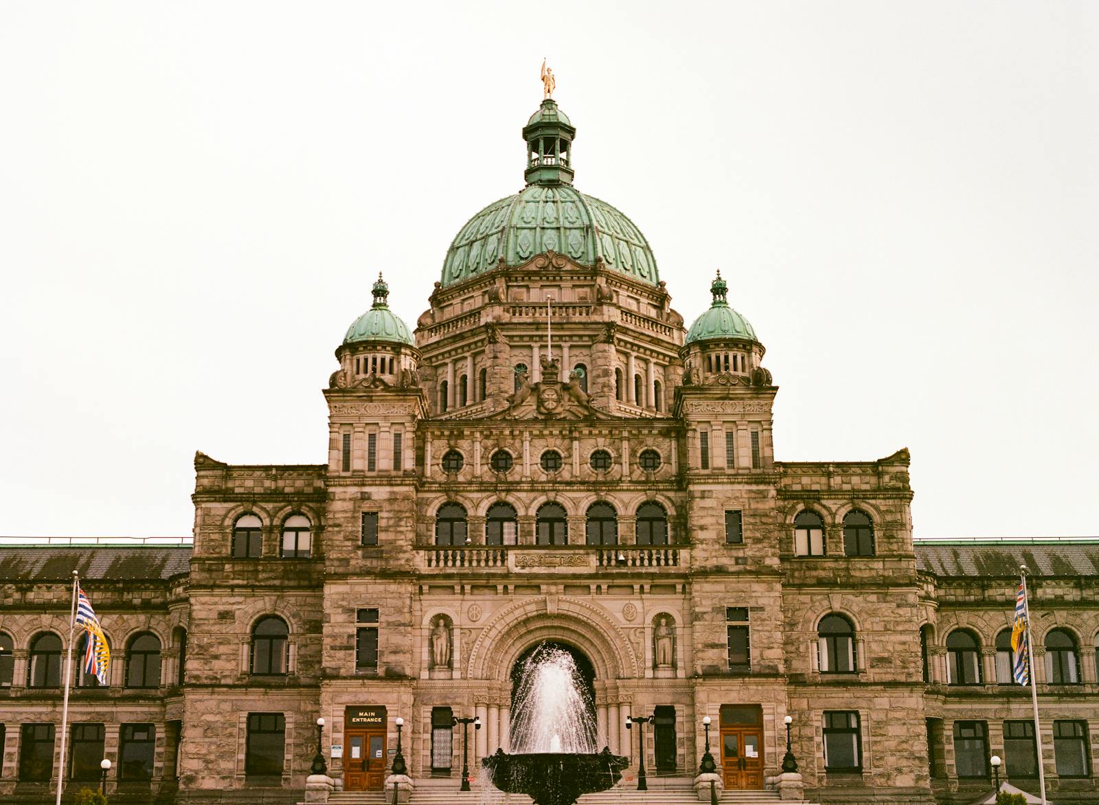 Front view of a grand historical building with a prominent dome and fountain.