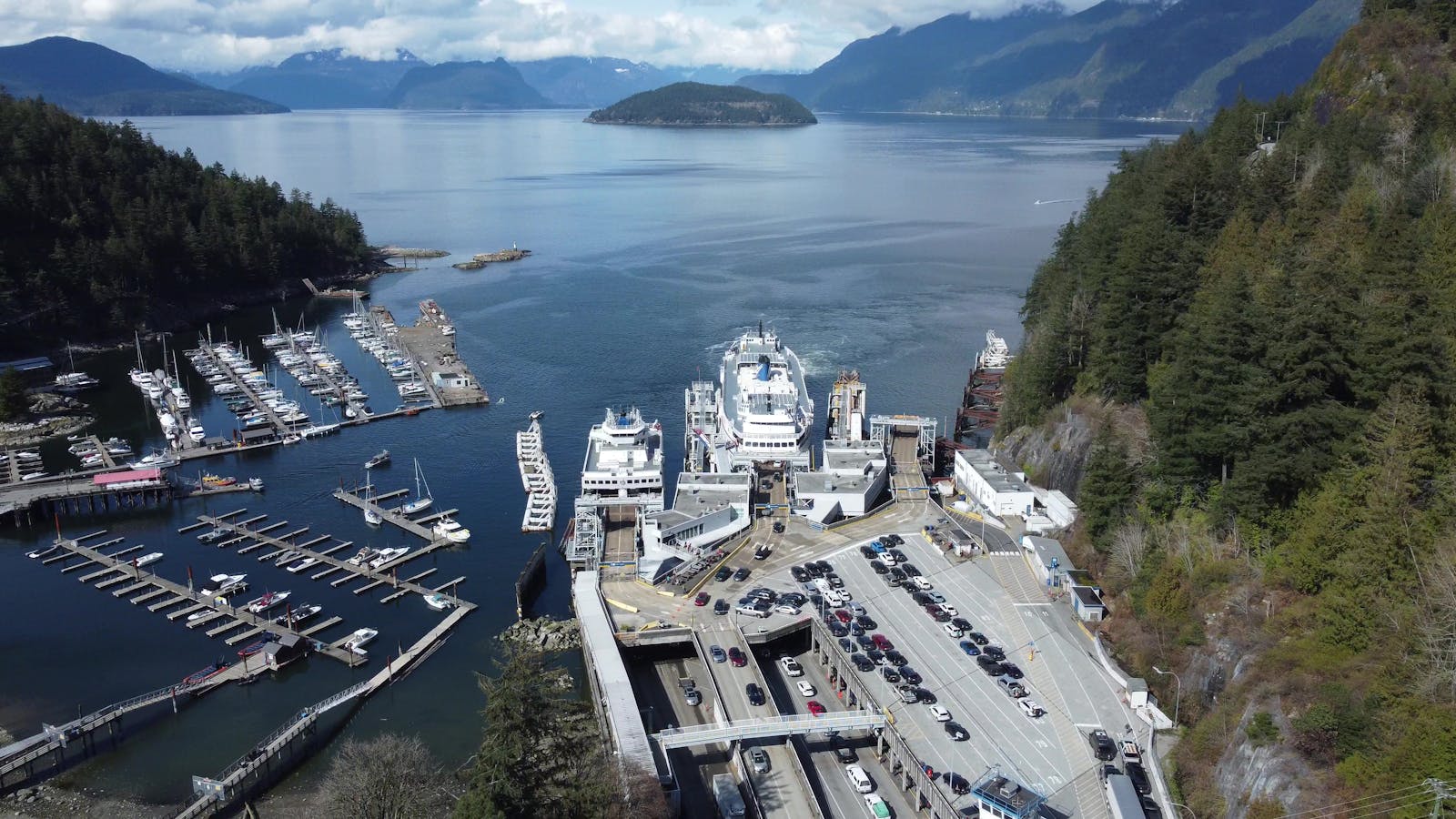 Aerial shot of Horseshoe Bay with ferries, docks, and scenic mountain views.