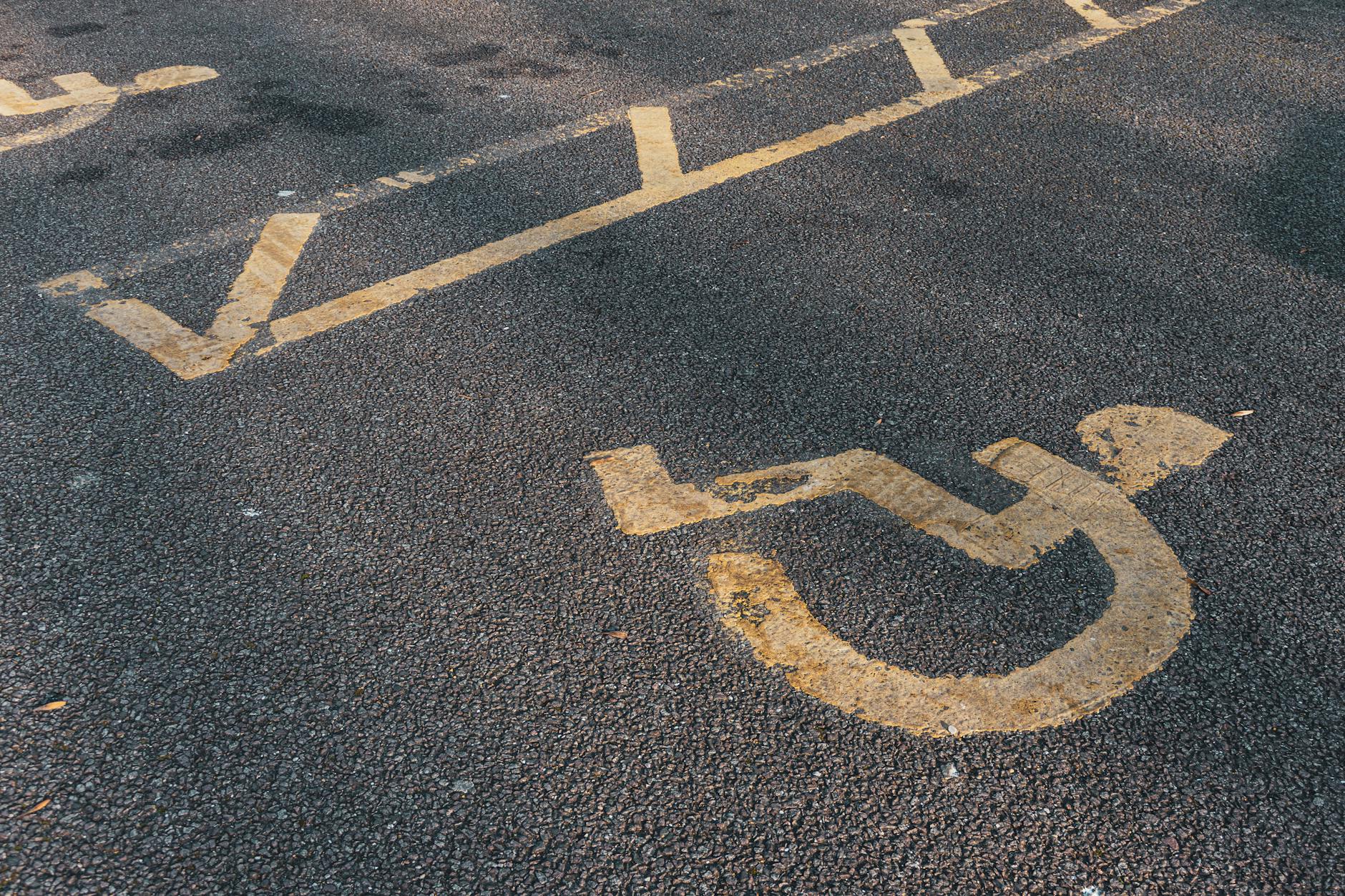 International wheelchair accessibility symbol on asphalt