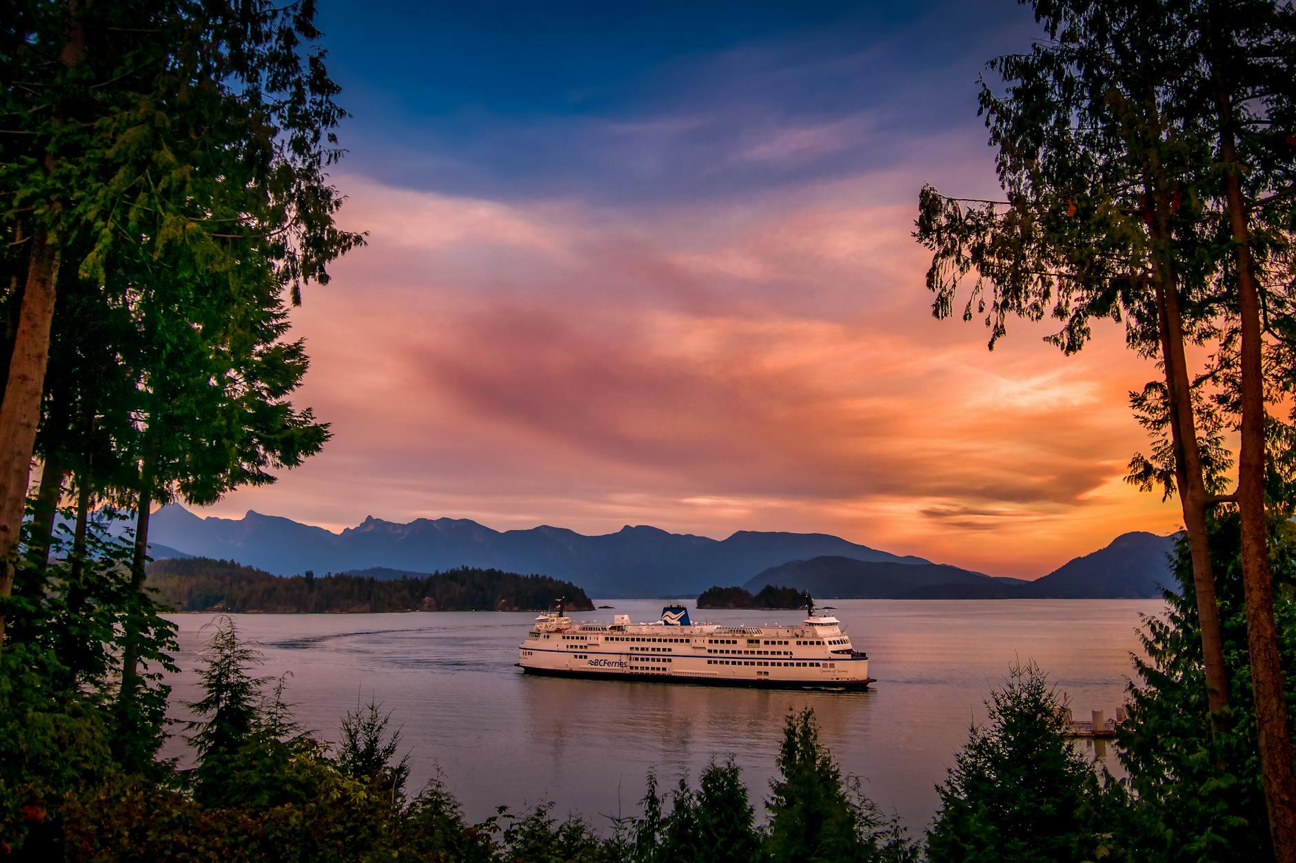 Ferry cruising through scenic British Columbia waters at sunset