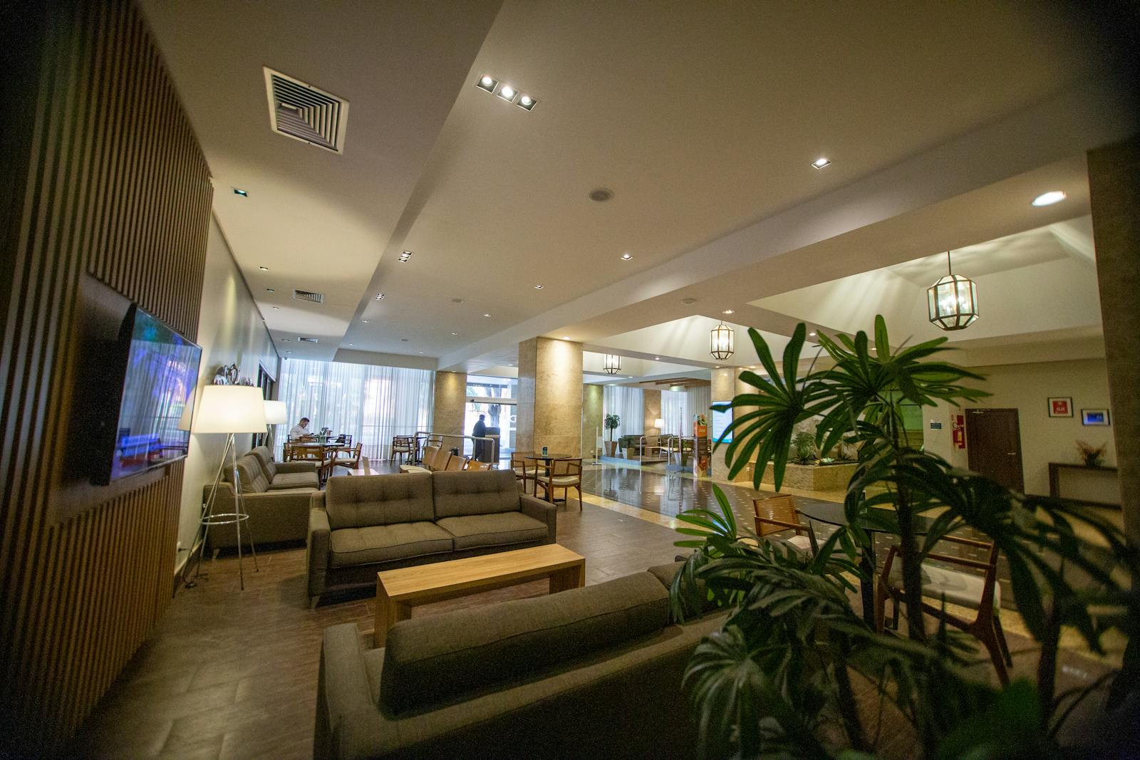 Spacious hotel lobby featuring modern furniture and bright lighting. Ideal for relaxation and business meetings.