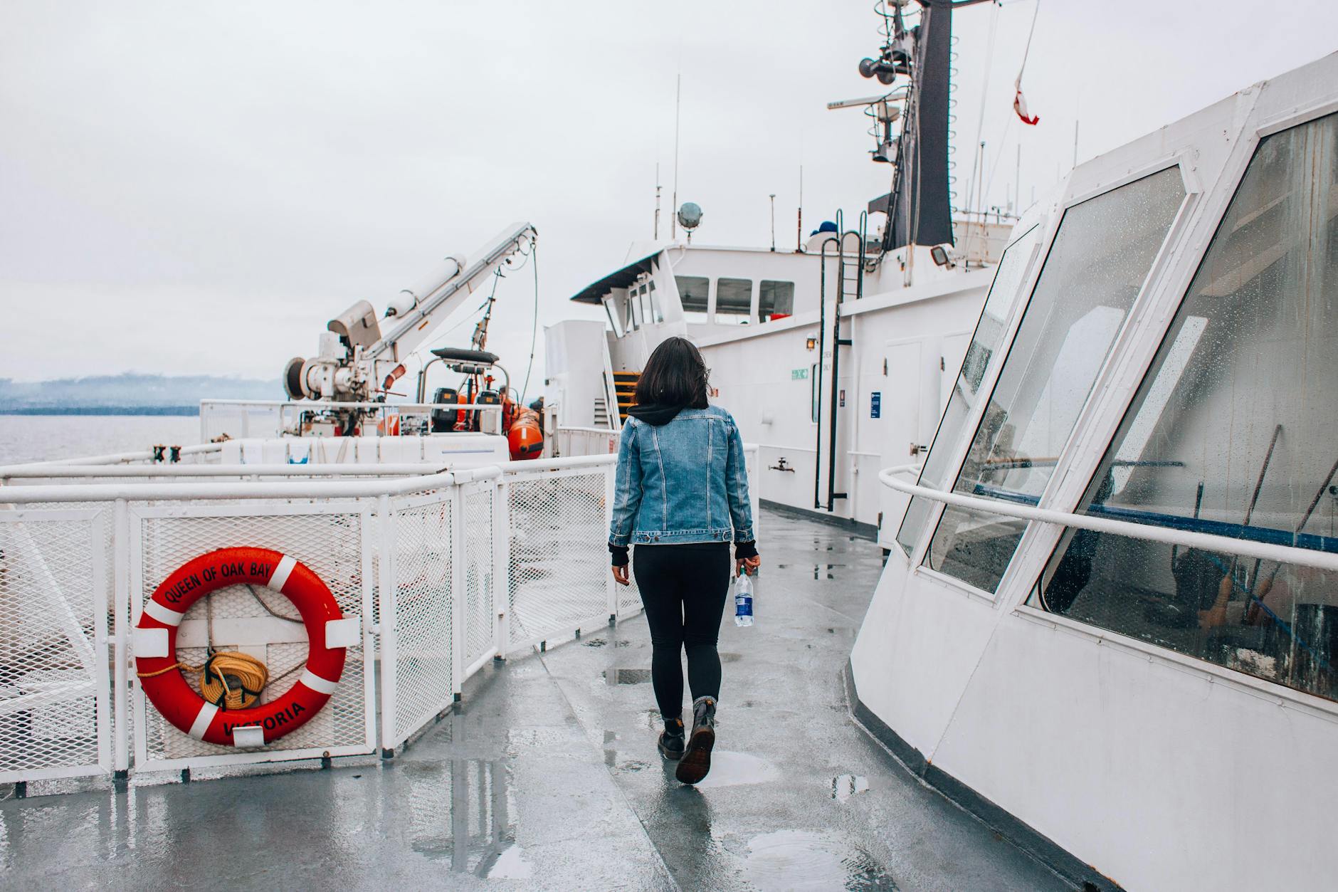 Woman walking on a ferry deck on a cloudy day