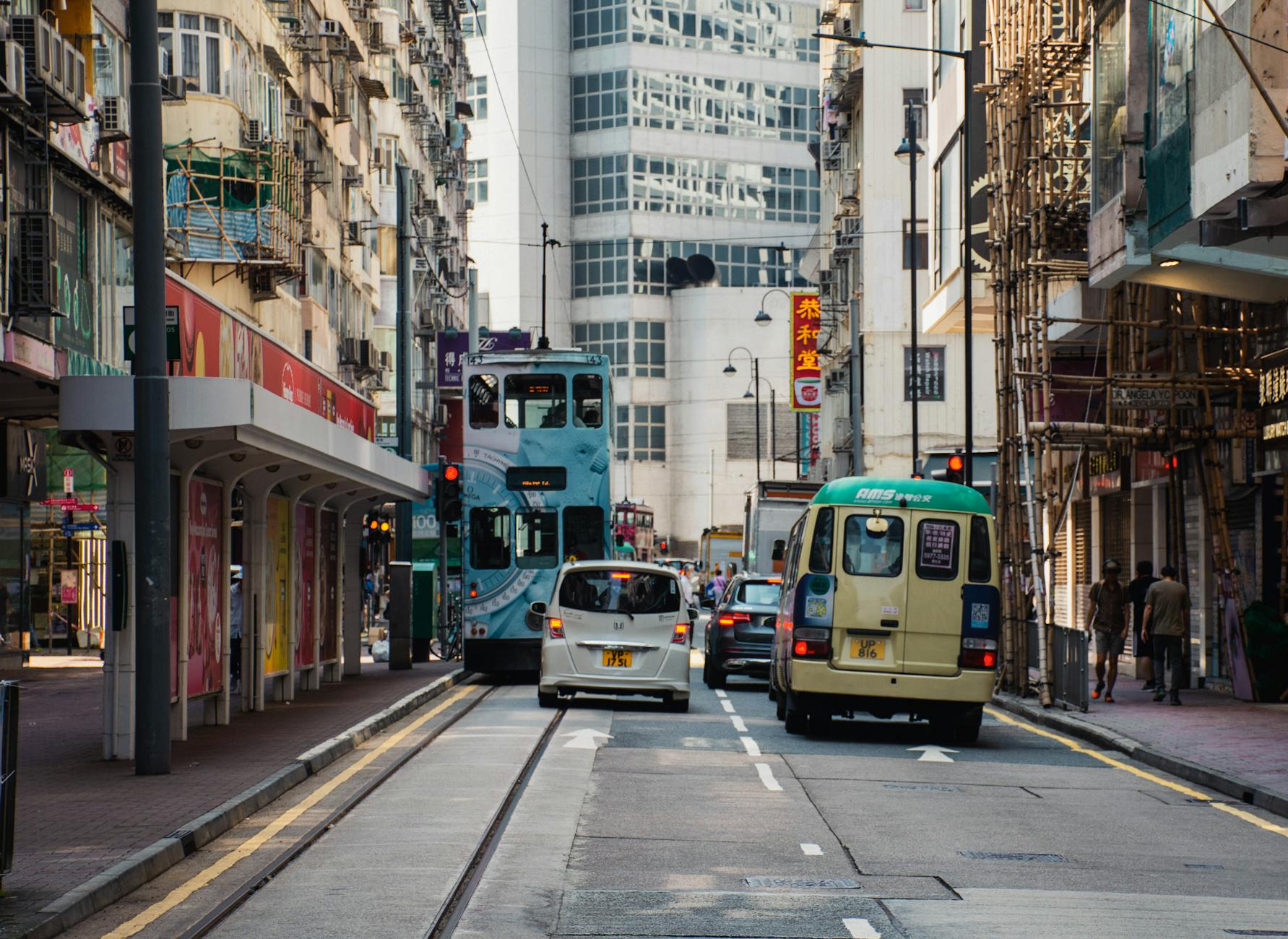 Wan Chai tram and woman traveler transport planning context.