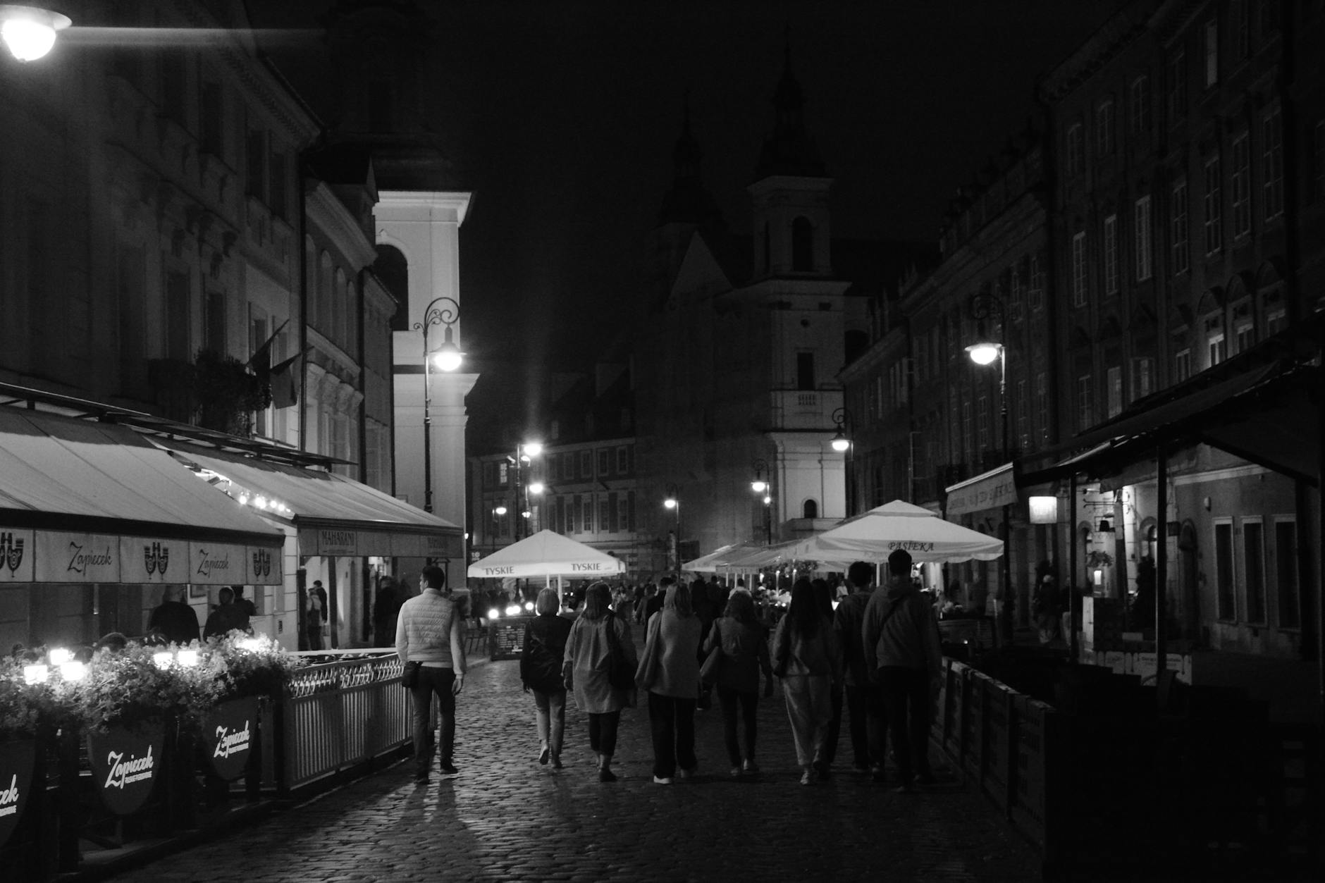 Warsaw evening street for nightlife district planning.