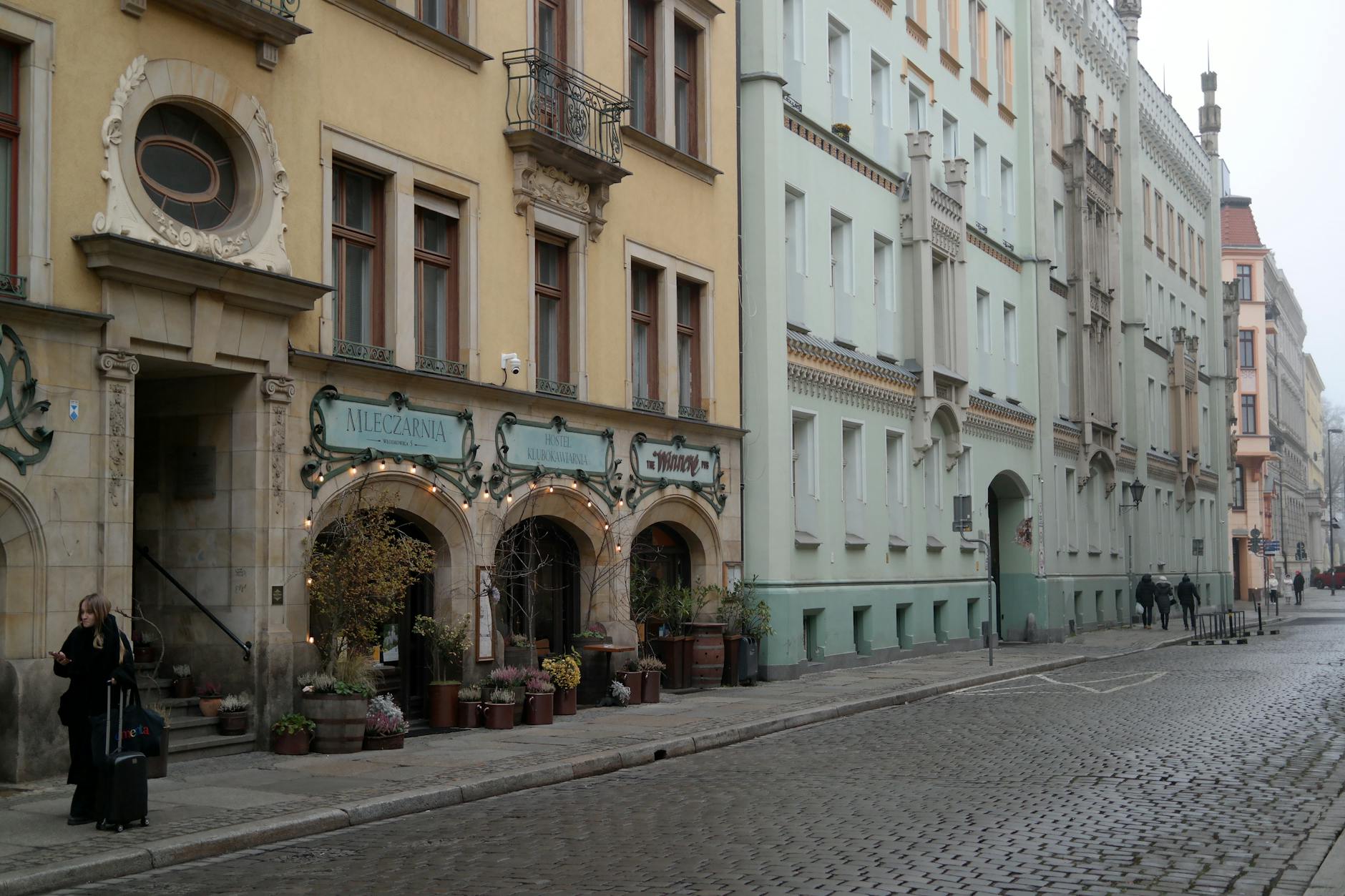 Wroclaw cafe setting for woman traveler day planning.