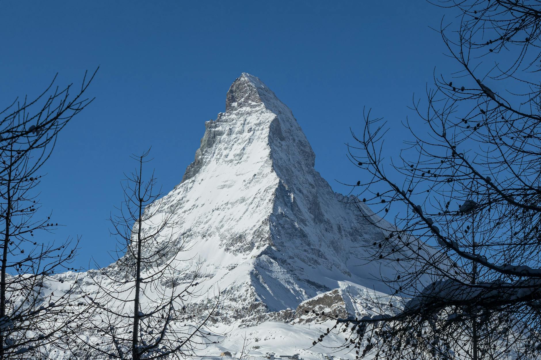 Skiers and Matterhorn for Zermatt budget travel planning.