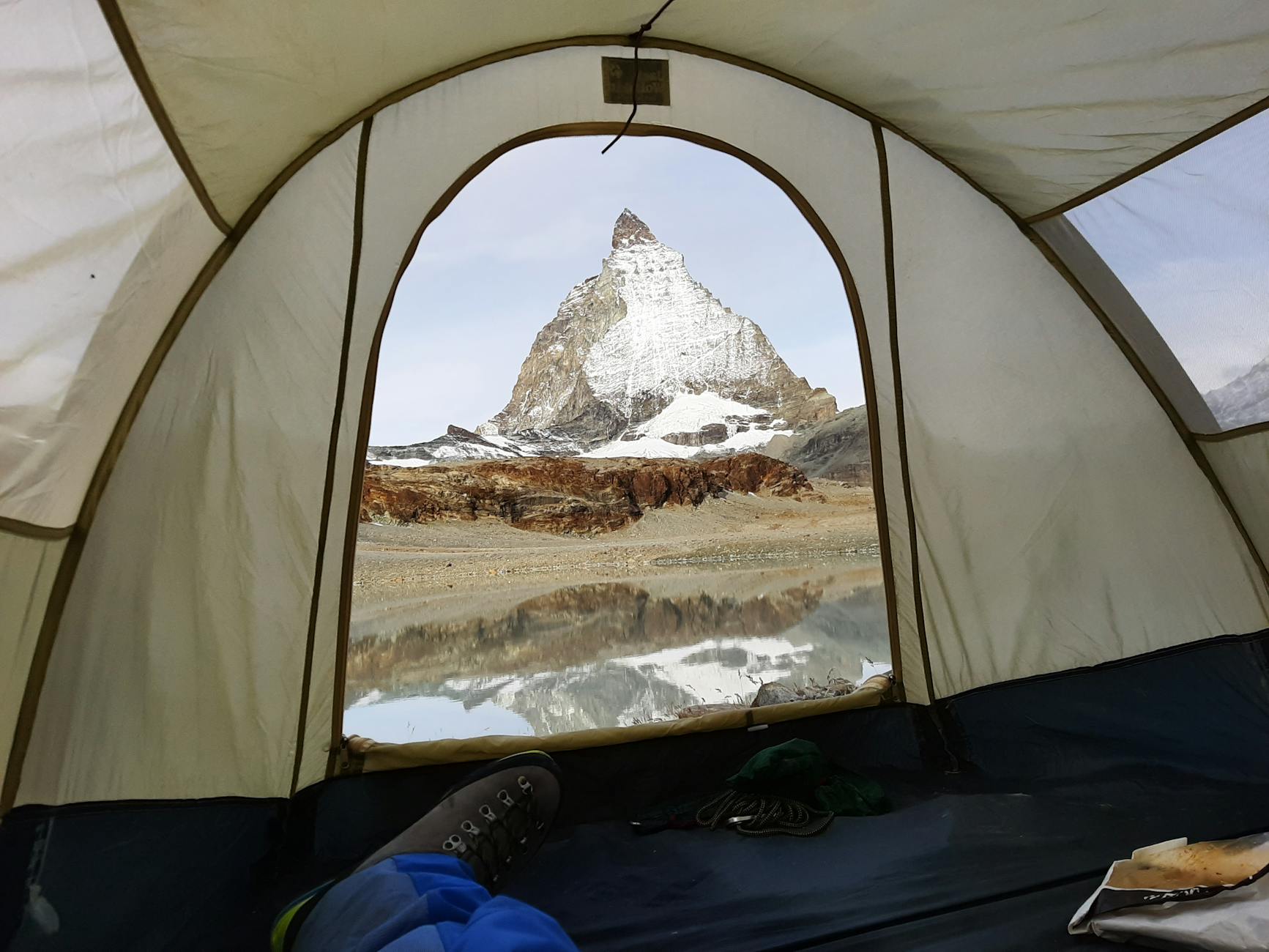 Matterhorn above a forested ridge for Zermatt budget report planning.