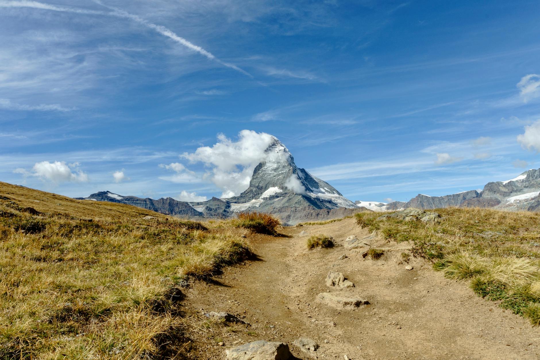 Matterhorn and rocky alpine trail for Zermatt conference travel report planning.