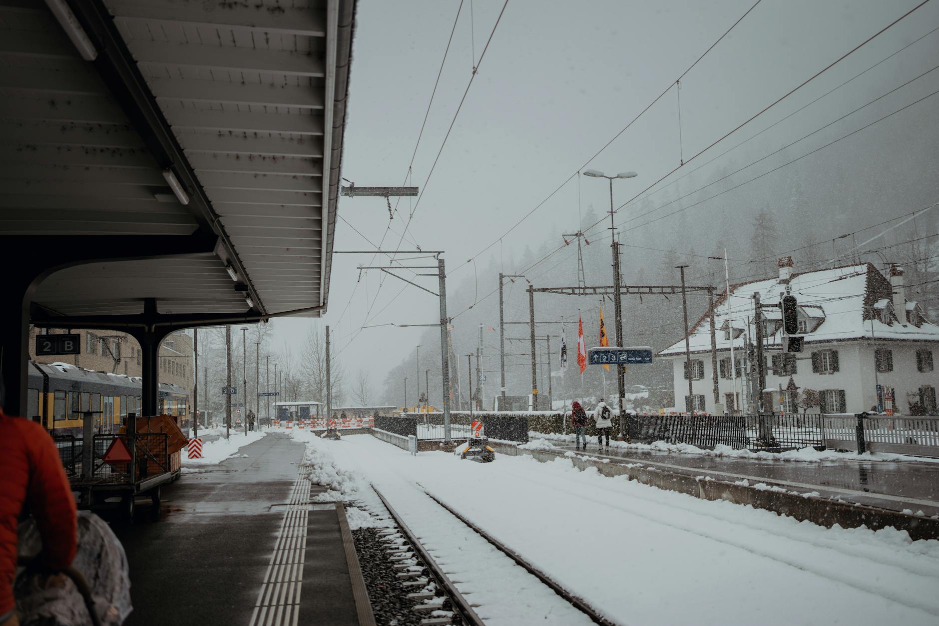 Snowy alpine train station for family arrival planning near Zermatt.