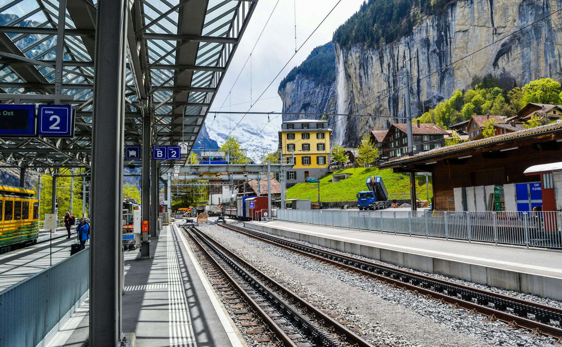 Swiss rail platform and mountains for family travel to Zermatt.