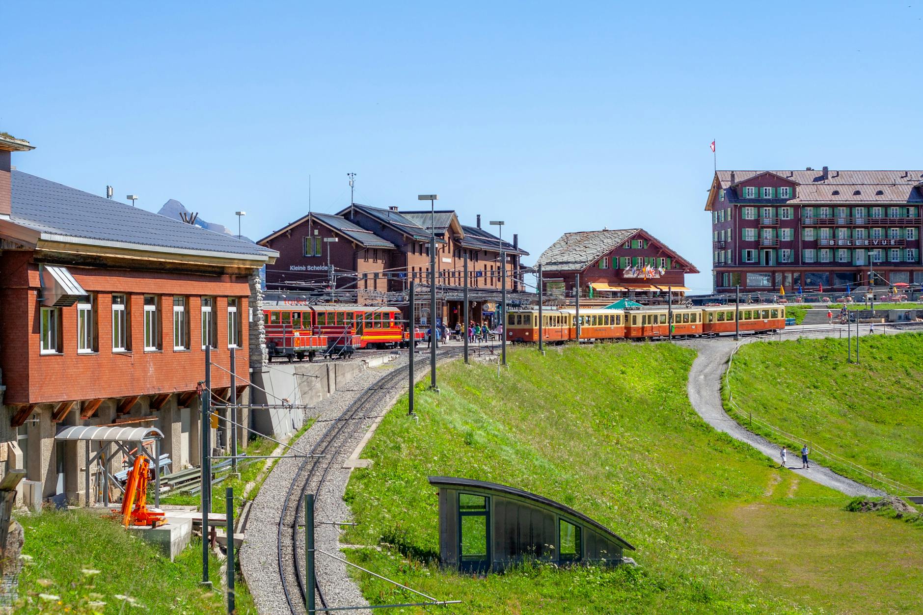 Colorful alpine train near mountain village for family lodging and rail planning.