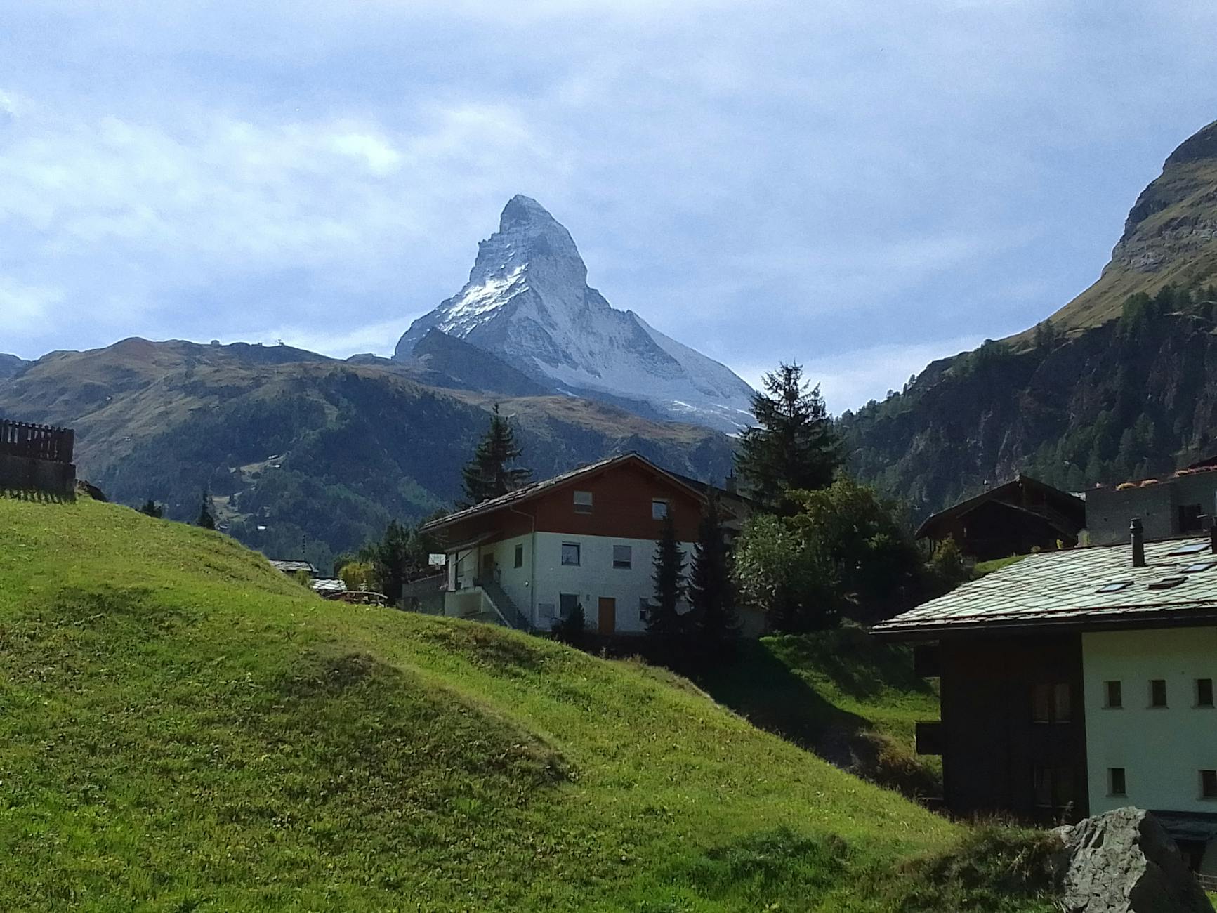 Matterhorn above Swiss chalets for Zermatt luxury travel planning.