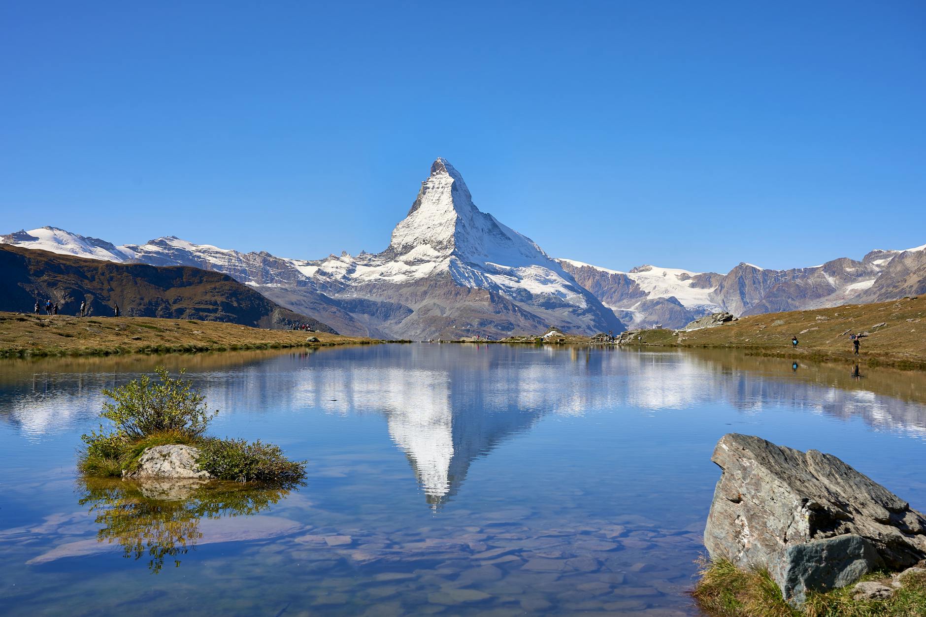 Matterhorn reflected in a clear alpine lake for medical travel report planning.