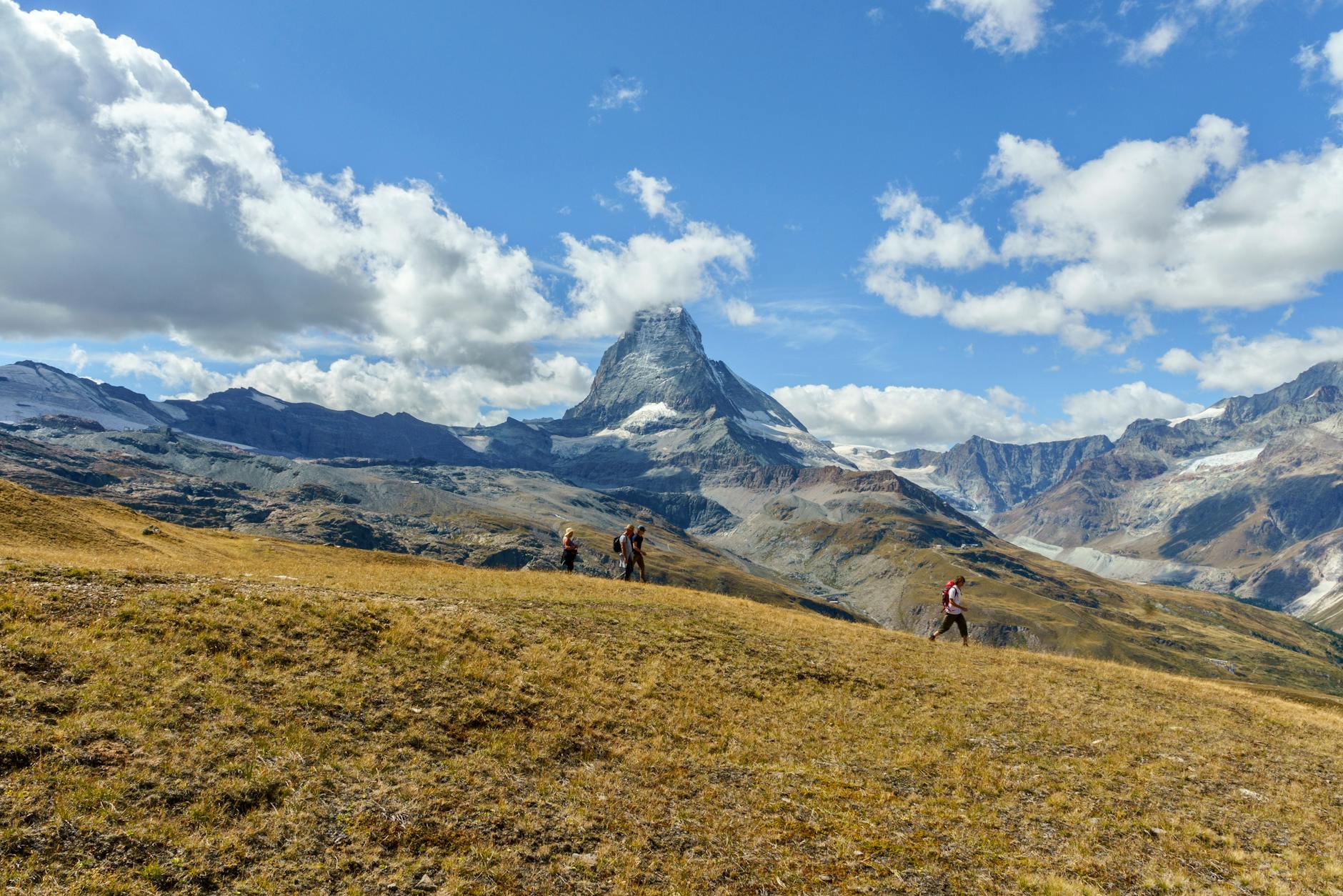 Hikers near the Matterhorn for Zermatt arrival and route awareness.