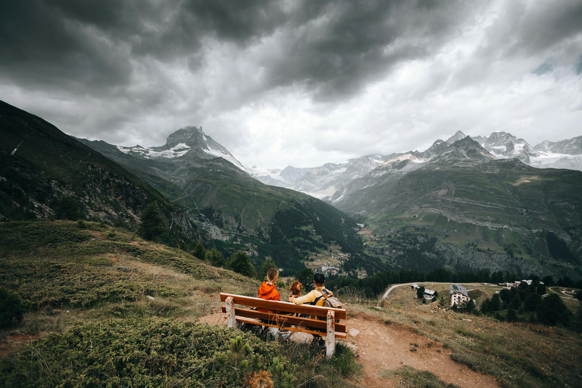 Travelers on a mountain bench for Zermatt evening and route planning.