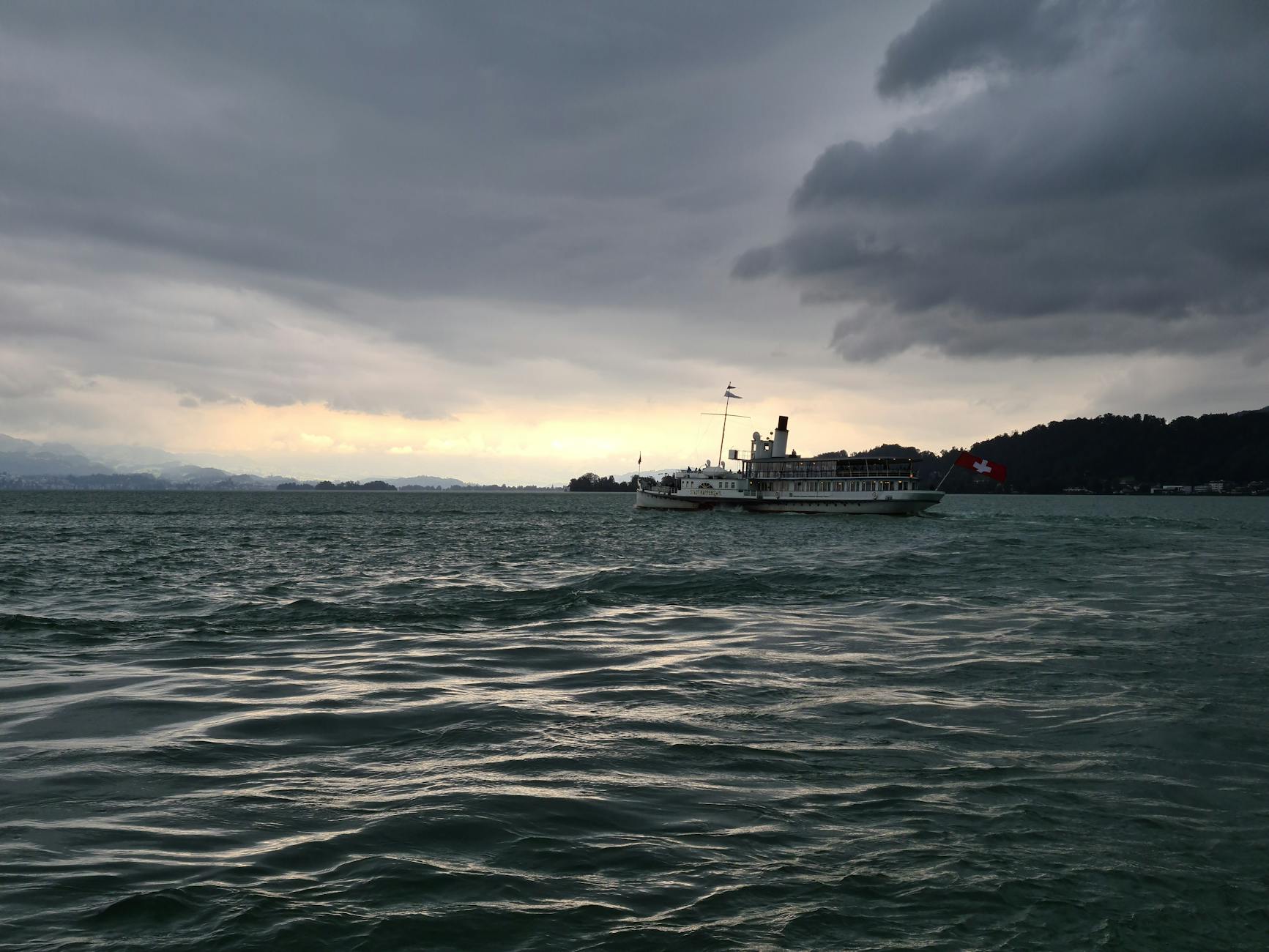 Ferry crossing a Swiss lake context for cruise hotel and transfer choices.